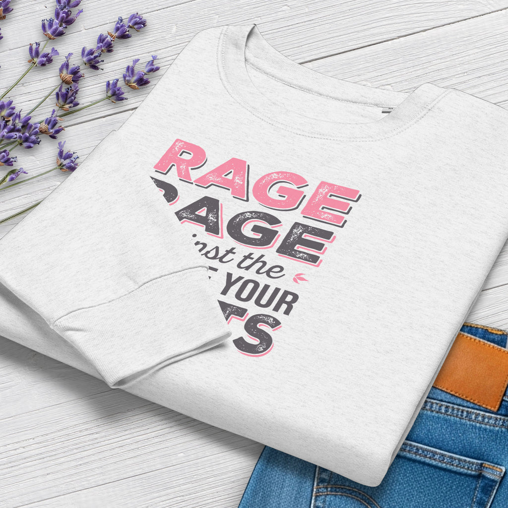 Folded grey protest sweatshirt with bold pink and grey text reading “rage rage against the dying of your rights” – feminist anti-trump activist shirt.