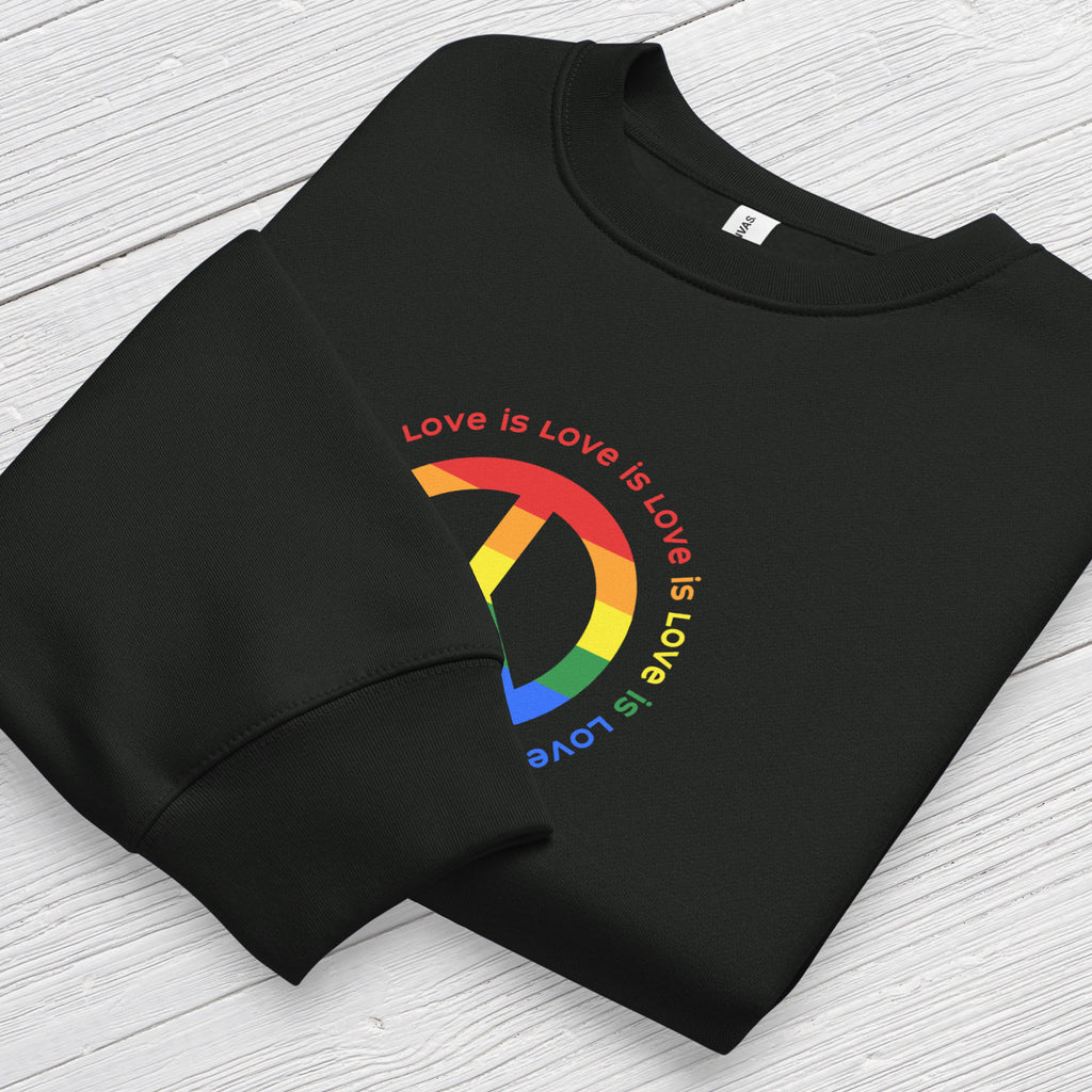 Folded black sweatshirt with LGBTQ pride graphic — a peace sign in the LGBTQ flag colors, with the text "love is love" repeated in a circle around the peace sign, showing cuff detail.