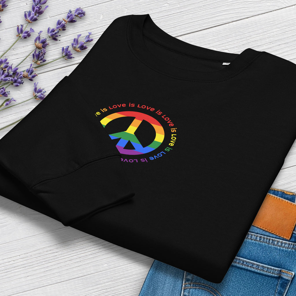 Folded black sweatshirt with LGBTQ pride graphic — a peace sign in the LGBTQ flag colors, with the text "love is love" repeated in a circle around the peace sign, showing cuff detail.