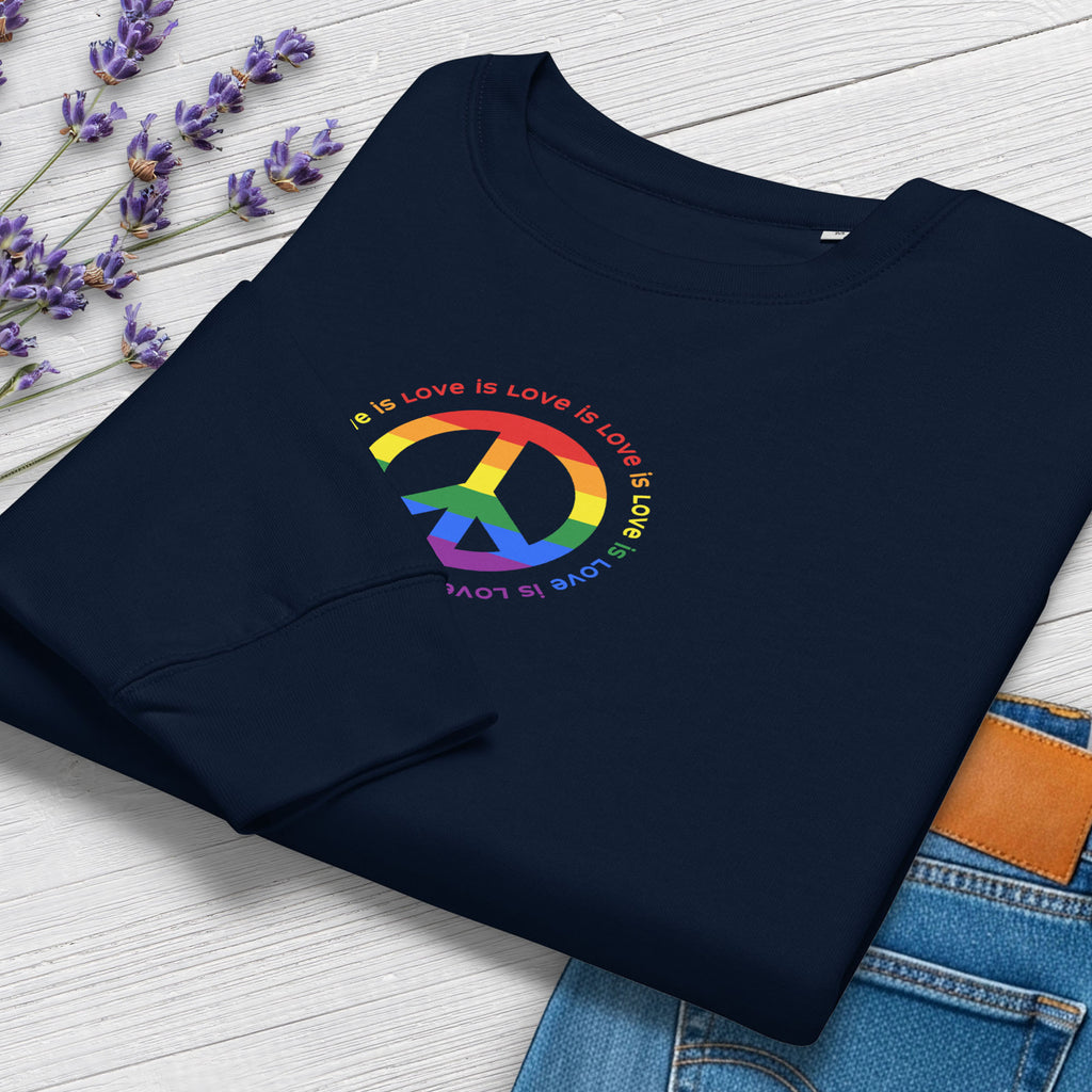 Folded navy sweatshirt with LGBTQ pride graphic — a peace sign in the LGBTQ flag colors, with the text "love is love" repeated in a circle around the peace sign, showing cuff detail.