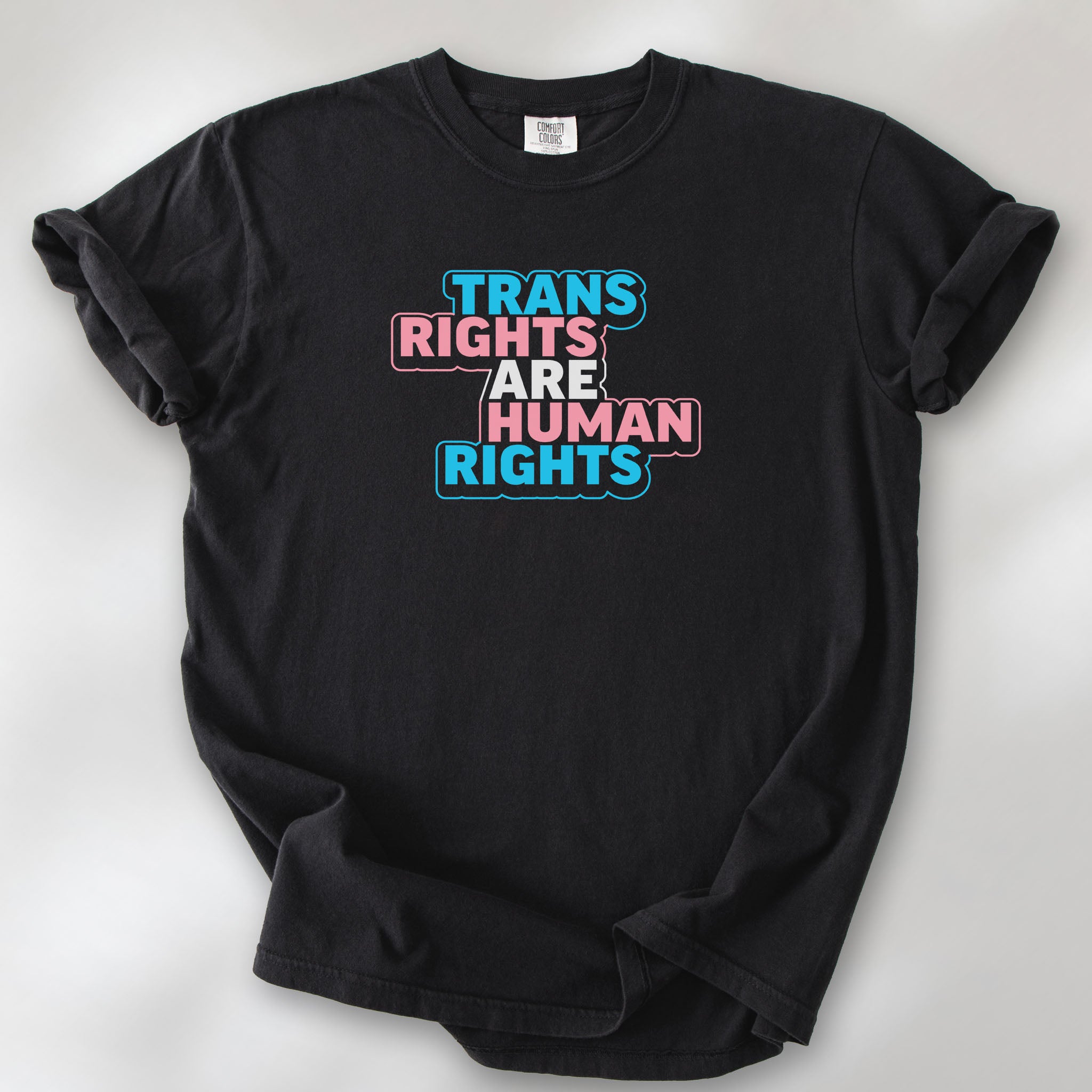 Black t-shirt with graphic reading "trans rights are human rights" in the colors of the trans flag.
