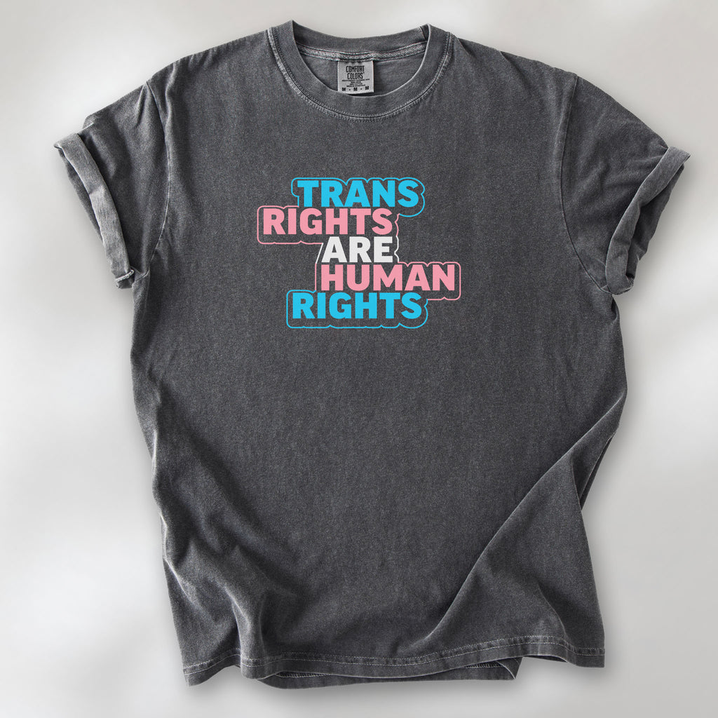 Pepper t-shirt with graphic reading "trans rights are human rights" in the colors of the trans flag.