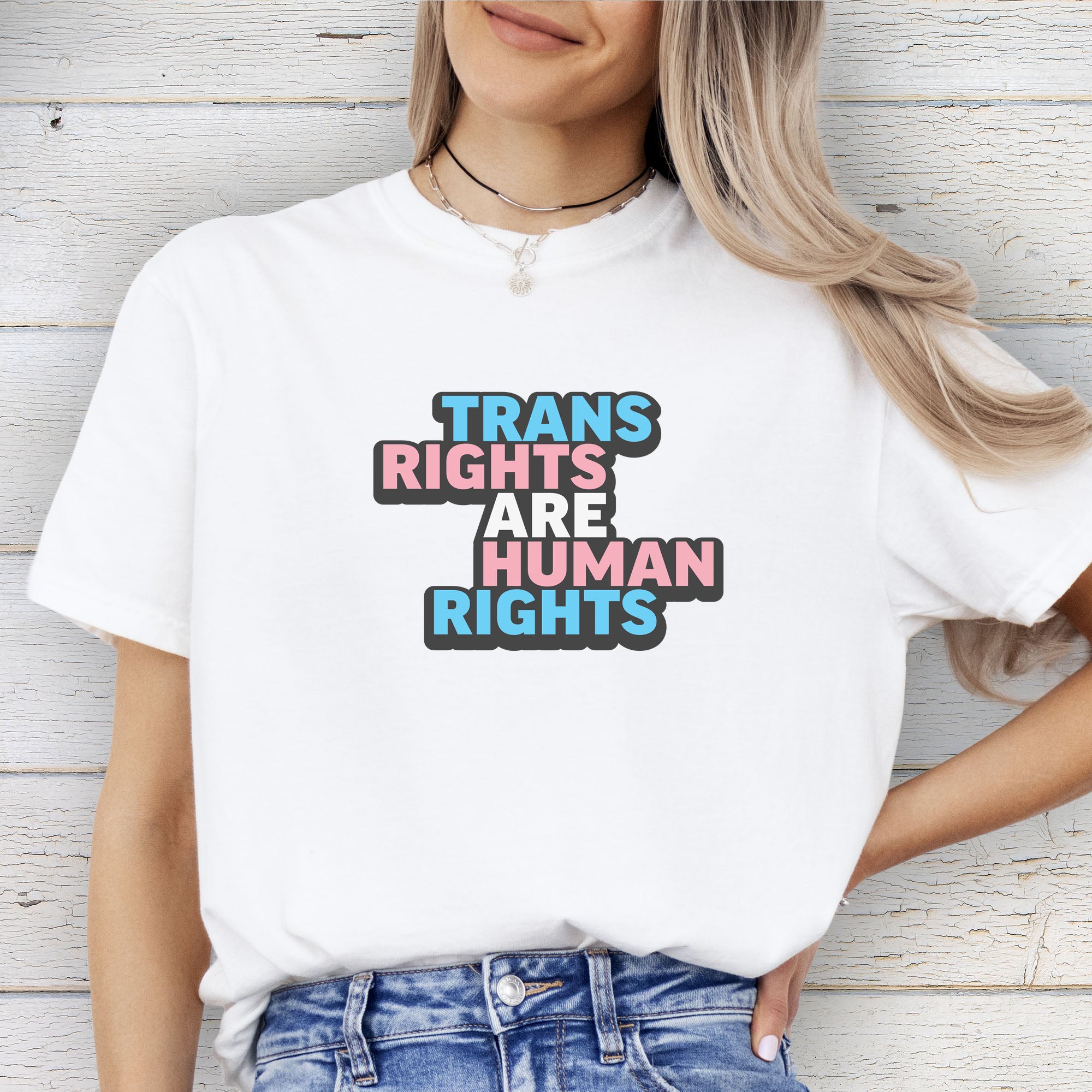 Female model wearing white color t-shirt with graphic that reads 