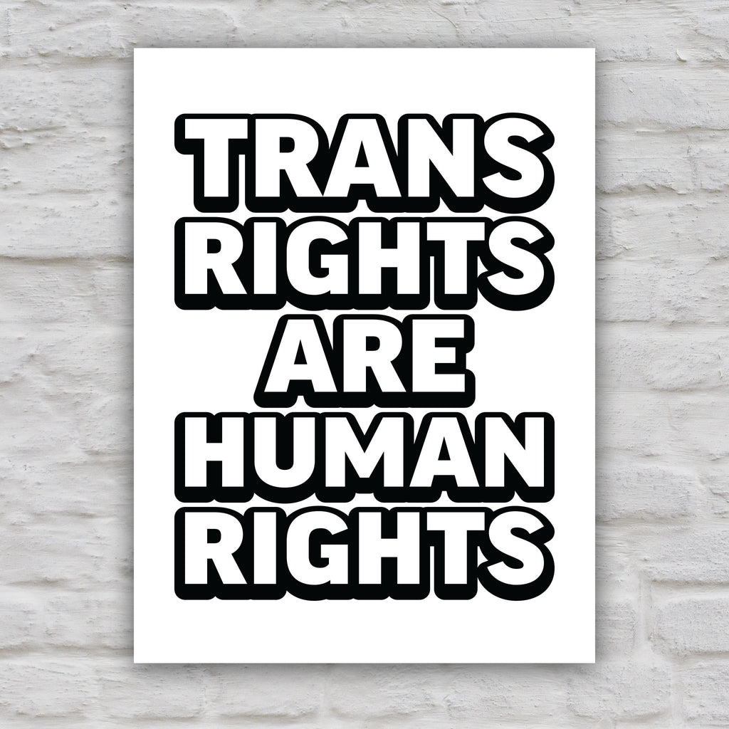 Black and white version of protest sign that reads “Trans Rights Are Human Rights” in bold lettering, symbolizing support for transgender equality and resistance to discrimination under the Trump administration.