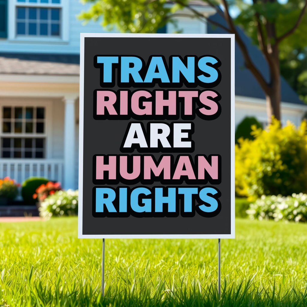 Yard sign that reads “Trans Rights Are Human Rights” in blue, pink, and white lettering, symbolizing support for transgender equality and resistance to discrimination under the Trump administration.