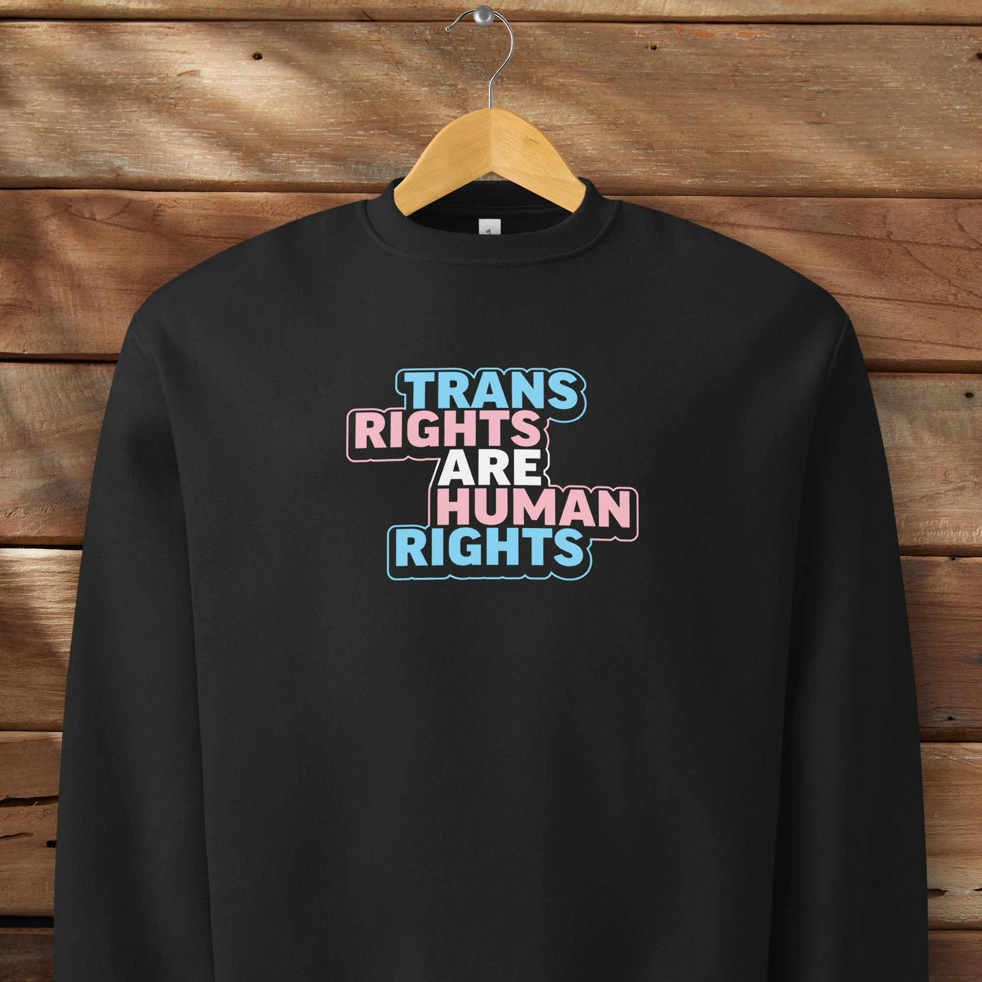 Black crewneck sweatshirt with graphic that reads 