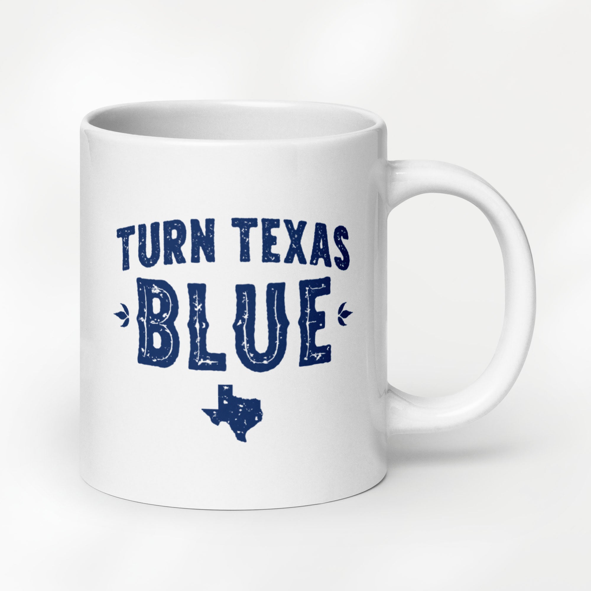 20 ounce white ceramic coffee mug featuring a distressed blue "Turn Texas Blue" design with a Texas state silhouette.
