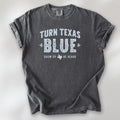 Pepper t-shirt featuring distressed "Turn Texas Blue" text with a small Texas icon and the phrase "Show Up Be Heard."
