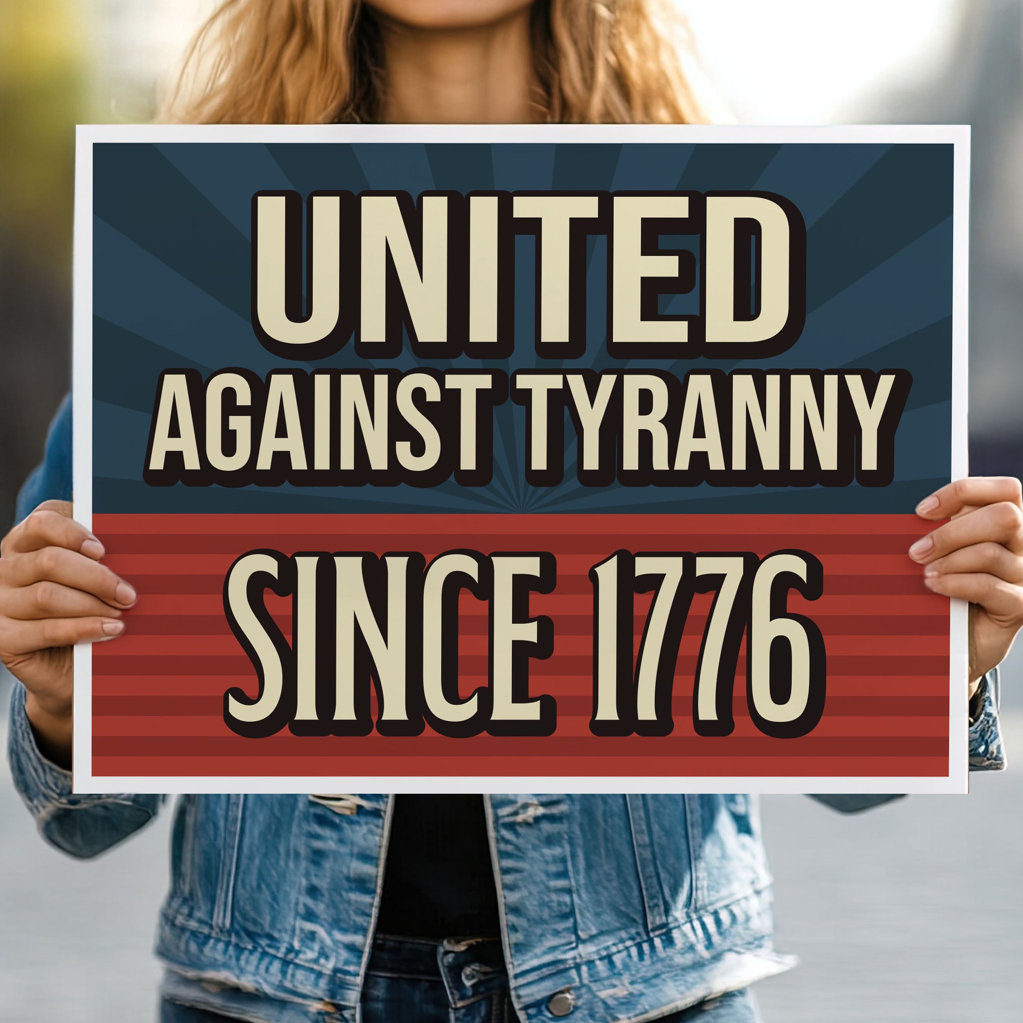 Person holding protest sign with blue and red background and gold text that reads "United against tyranny since 1776."
