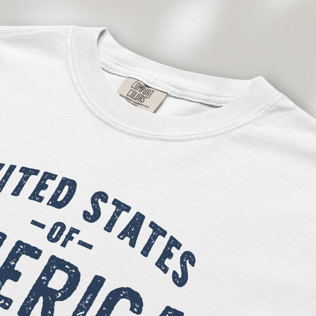 Closeup detail of white t-shirt with vintage style text reading “United States of America — Celebrating 250 Years — Est 1776”.