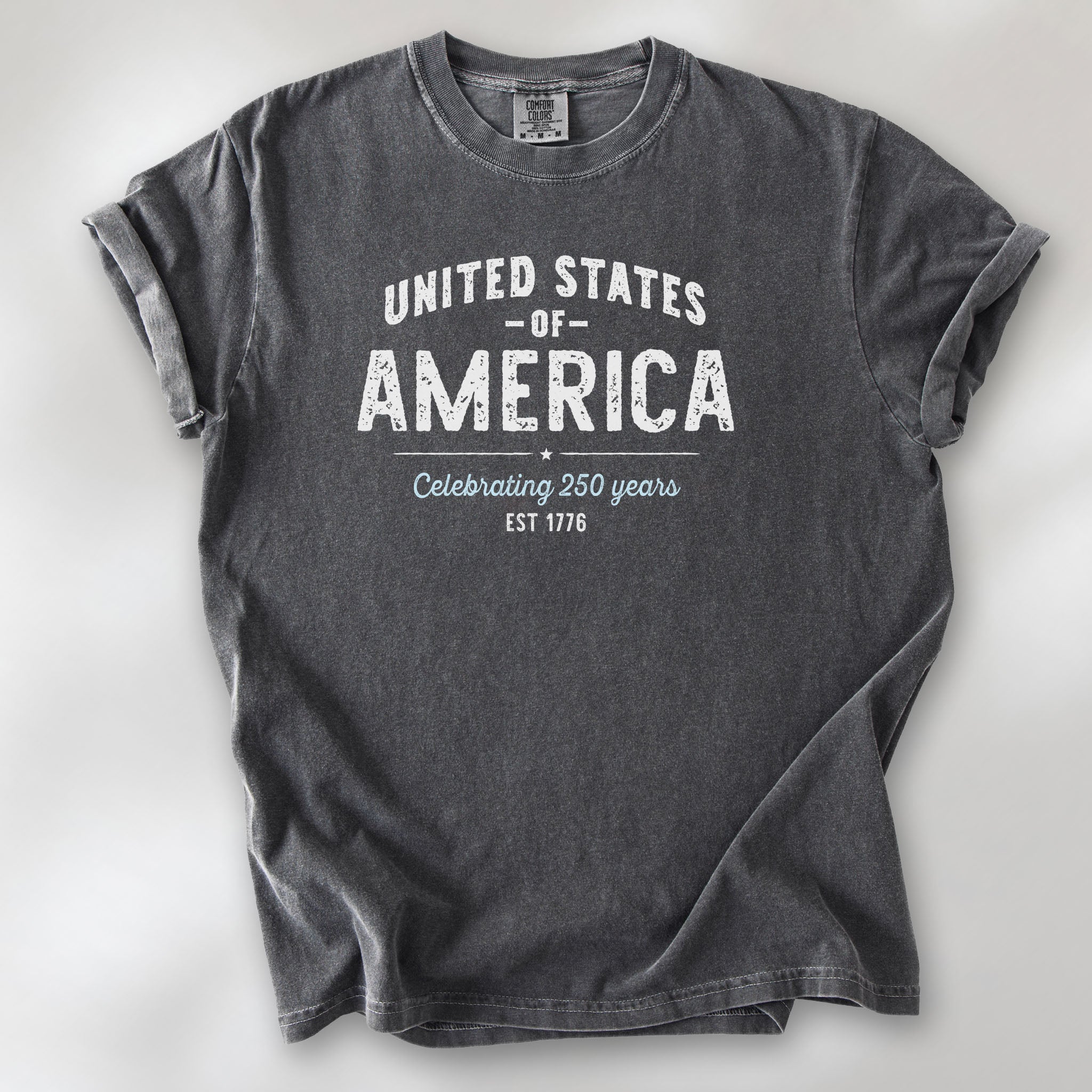 Pepper t-shirt with vintage style text reading “United States of America — Celebrating 250 Years — Est 1776”. 