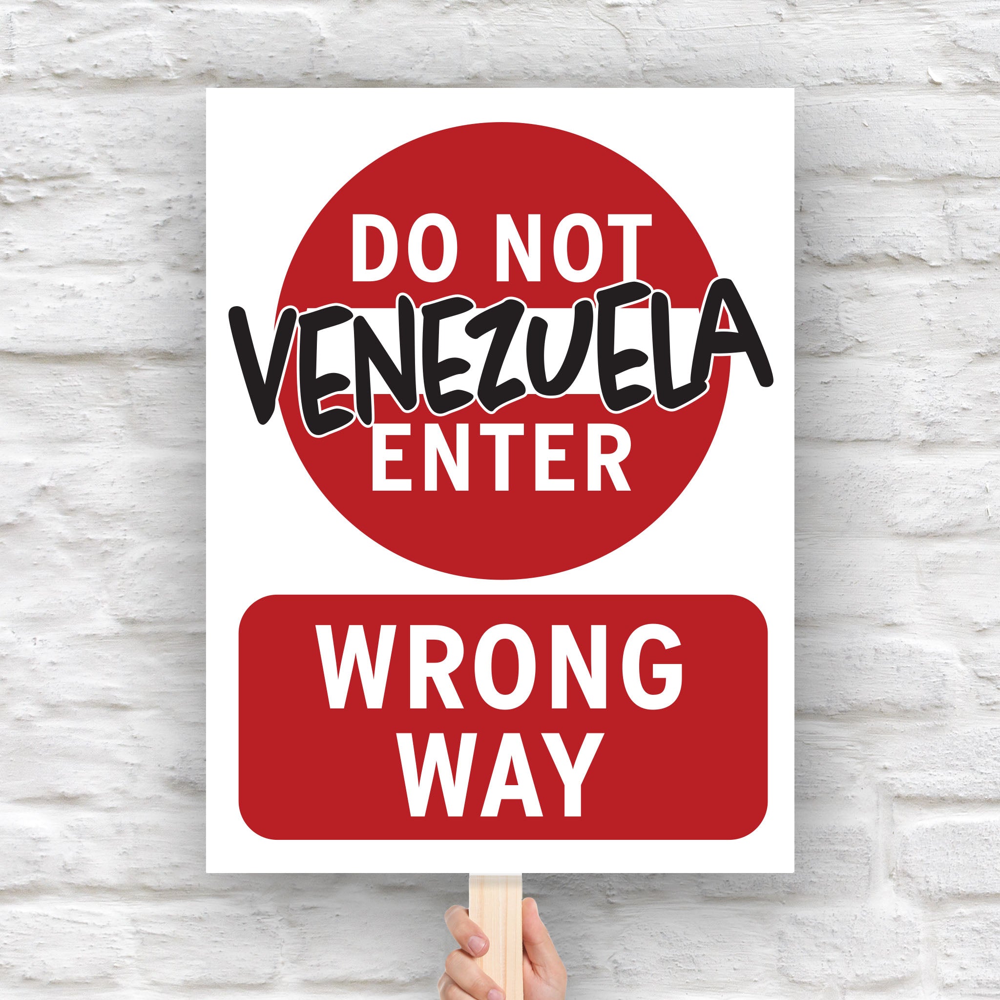 Anti-Trump protest sign that looks like a "do not enter" street sign that reads "do not enter Venezuela; wrong way."