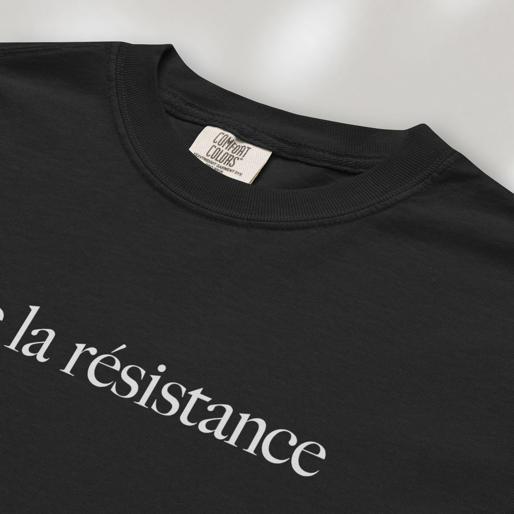 Closeup detail of black t-shirt with minimalist serif text reading “vive la résistance.”