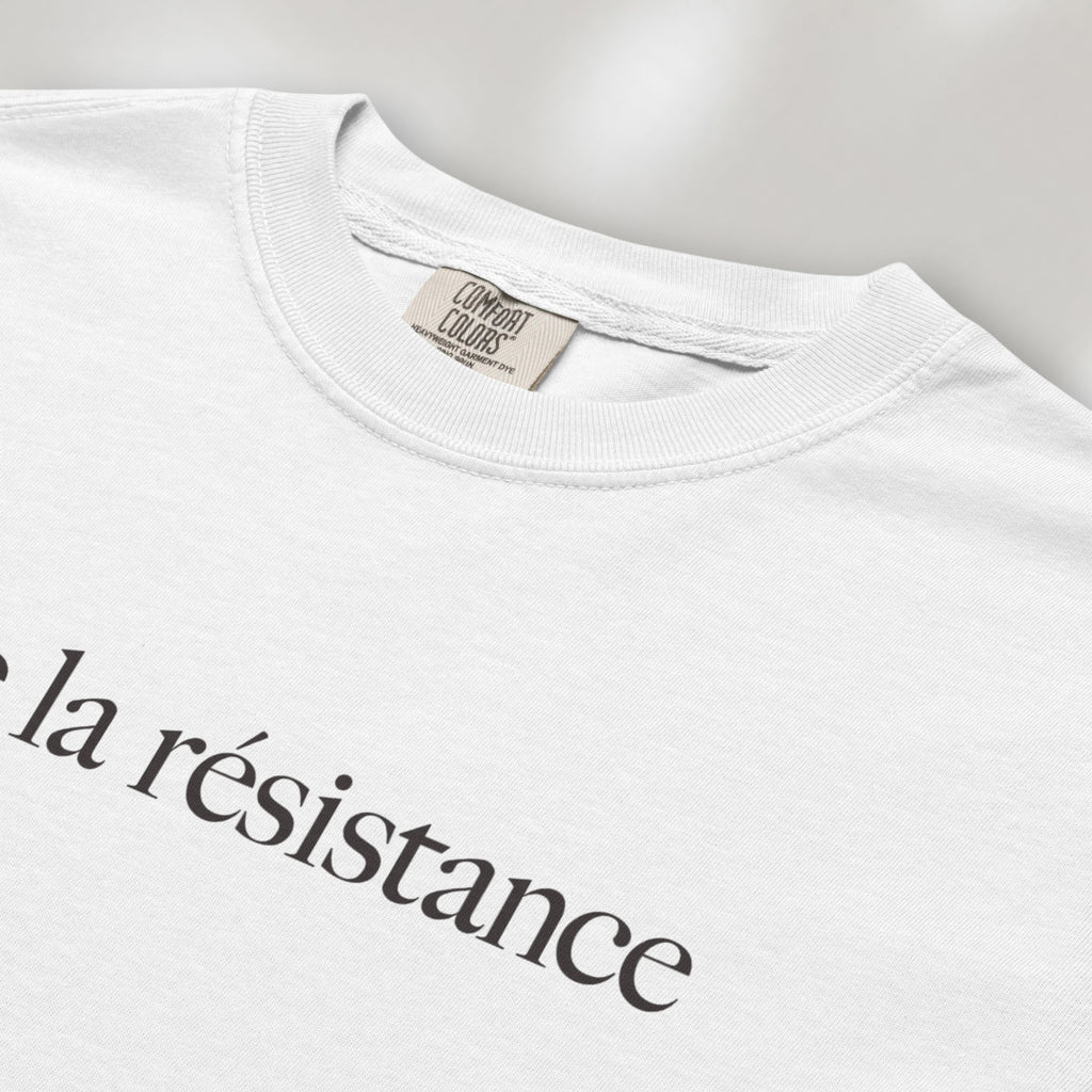 Closeup detail of white t-shirt with minimalist serif text reading “vive la résistance.”