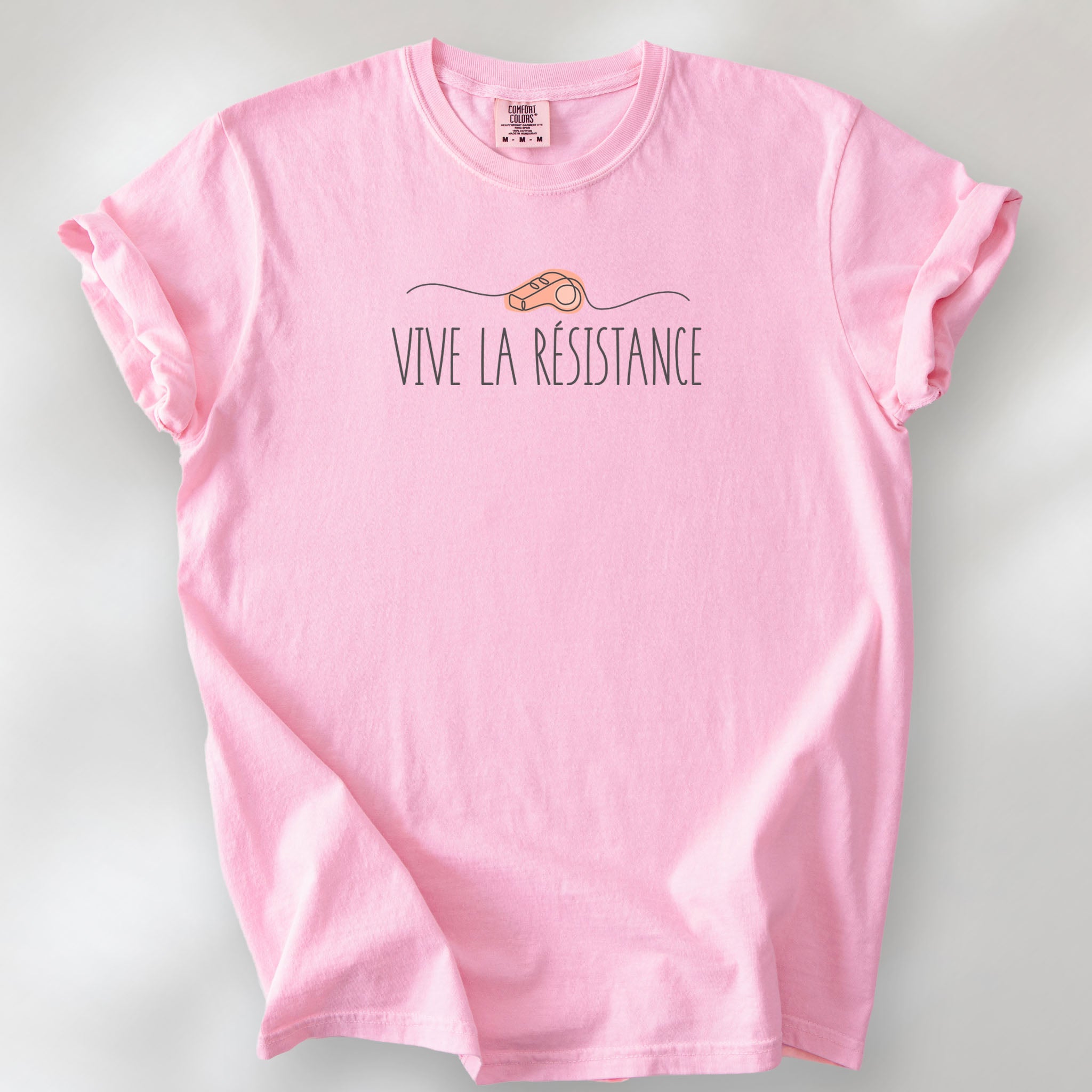 Blossom unisex t-shirt reading “Viva La Resistance” with a whistle illustration referencing community alert systems used to warn neighbors of ICE presence.