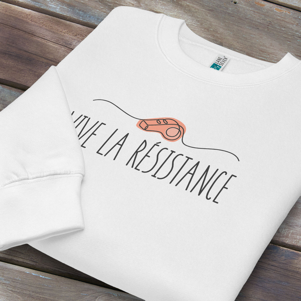 Folded white sweatshirt reading “Viva La Resistance” with a whistle illustration referencing community alert systems used to warn neighbors of ICE presence.