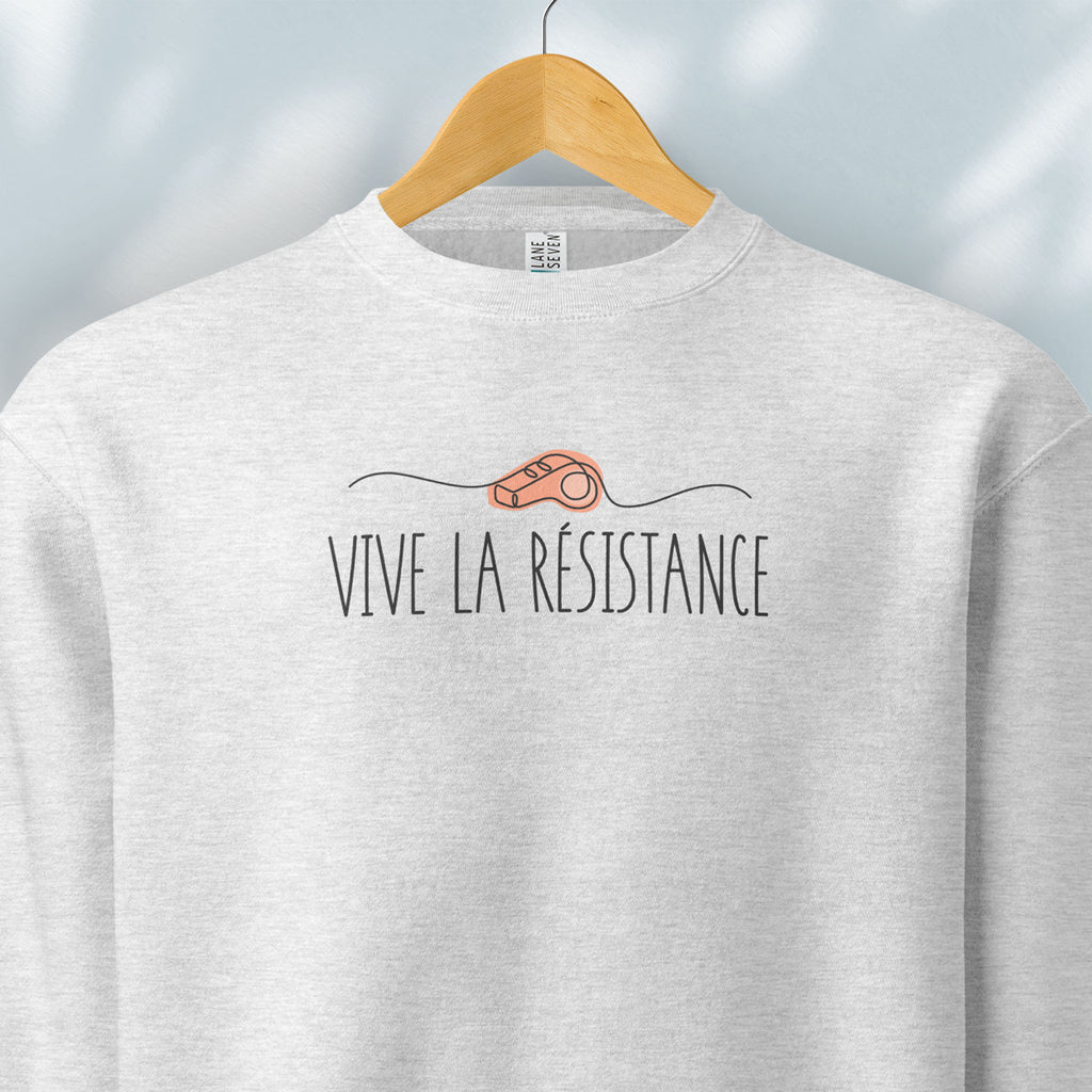 Hanging grey sweatshirt reading “Viva La Resistance” with a whistle illustration referencing community alert systems used to warn neighbors of ICE presence.