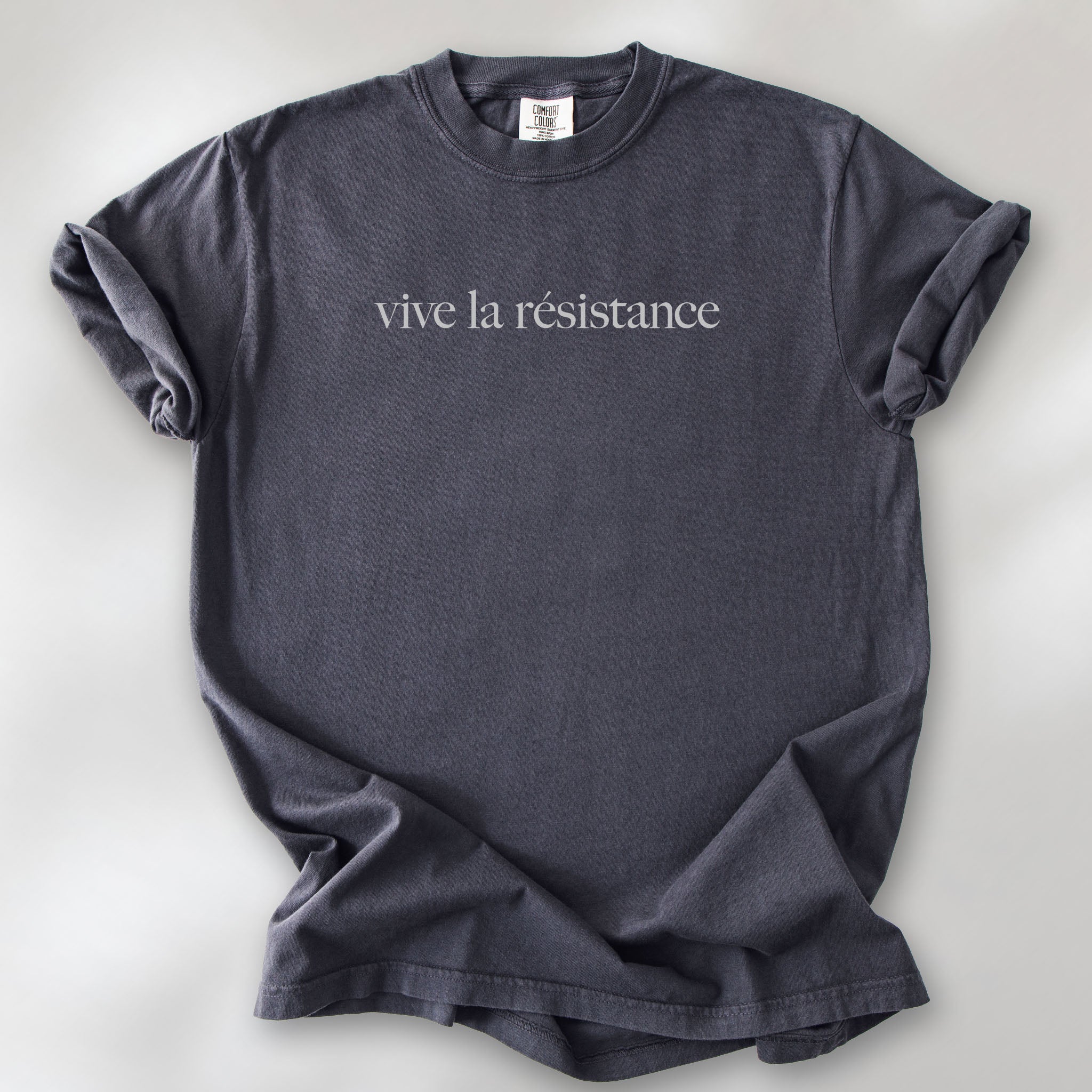 Graphite t-shirt with minimalist serif text reading “vive la résistance.”