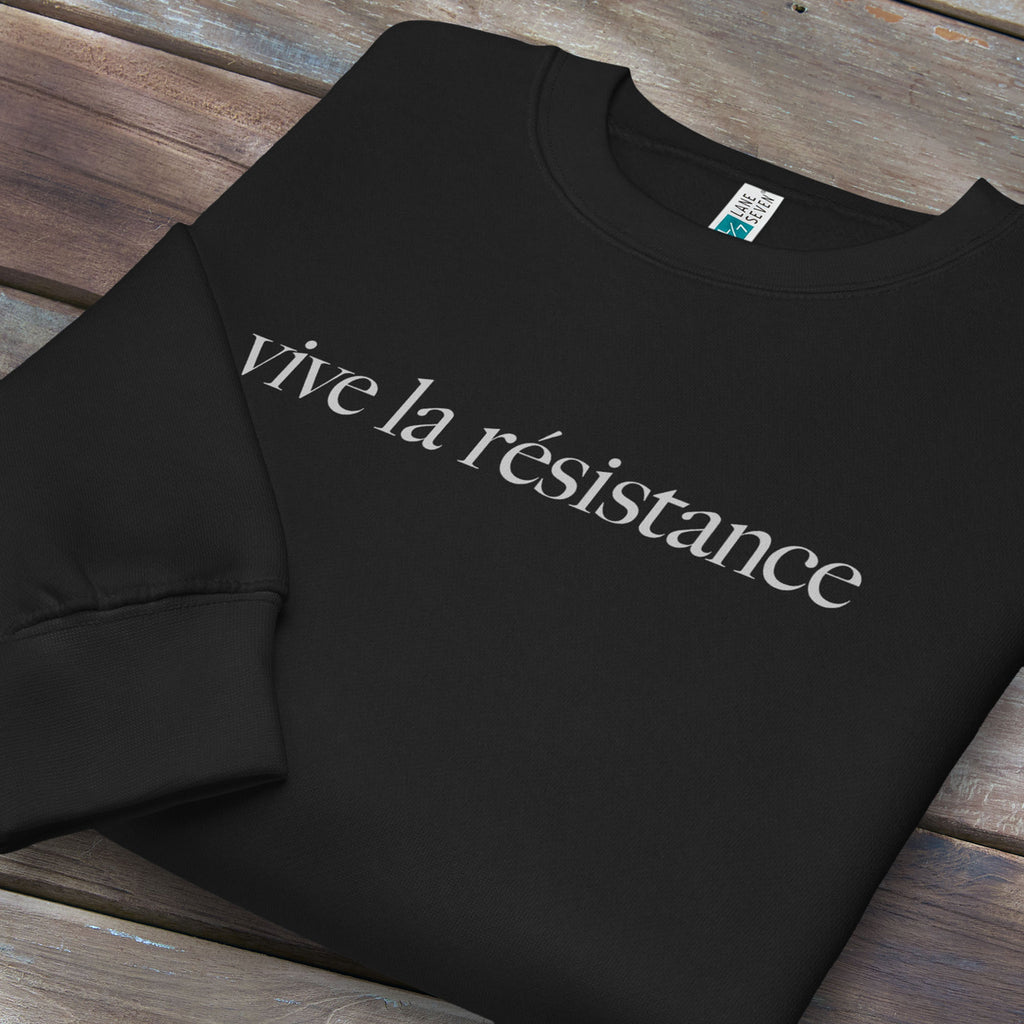 Folded black sweatshirt with minimalist serif text reading “vive la résistance.”