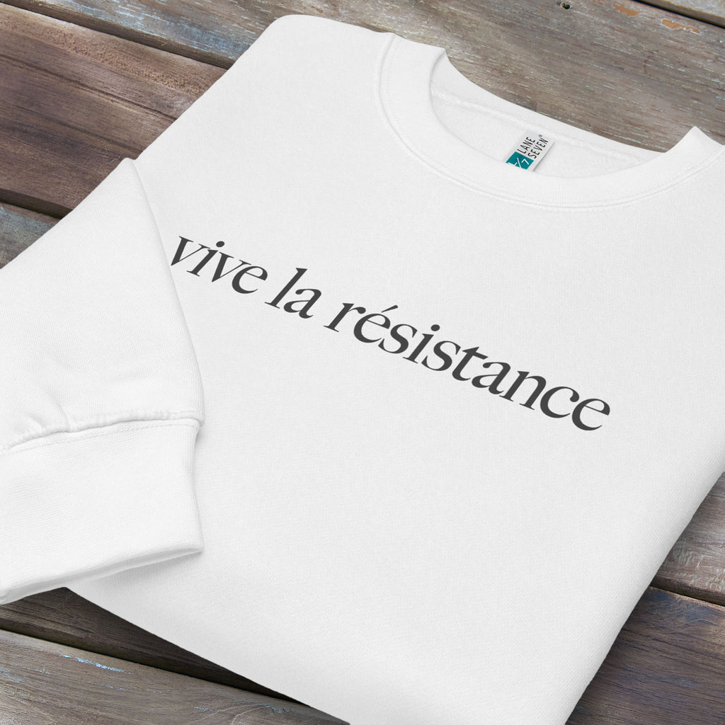 Folded white sweatshirt with minimalist serif text reading “vive la résistance.”