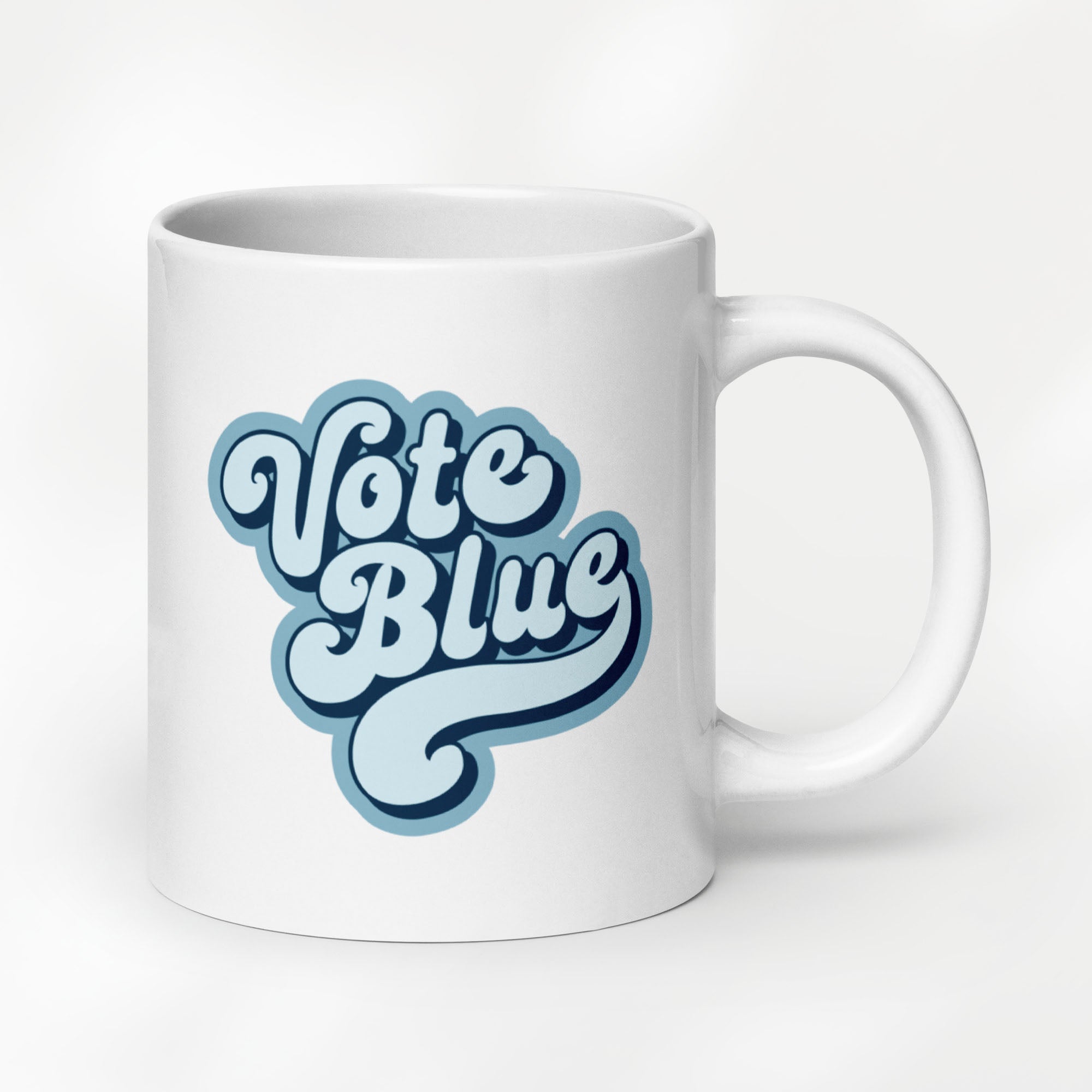20 ounce white ceramic coffee mug featuring a retro blue “Vote Blue” script design.