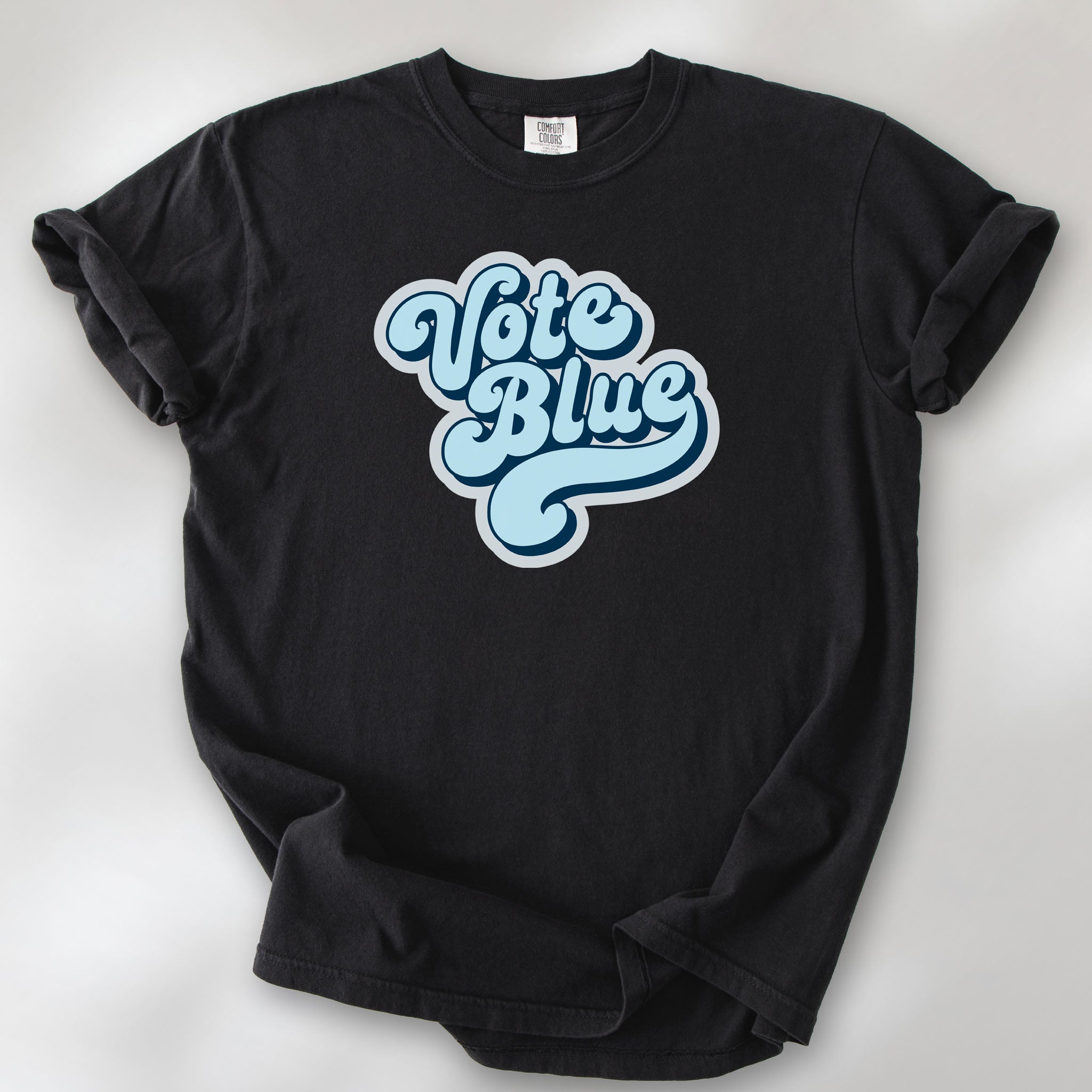 Black t-shirt featuring a retro blue "Vote Blue" script graphic.