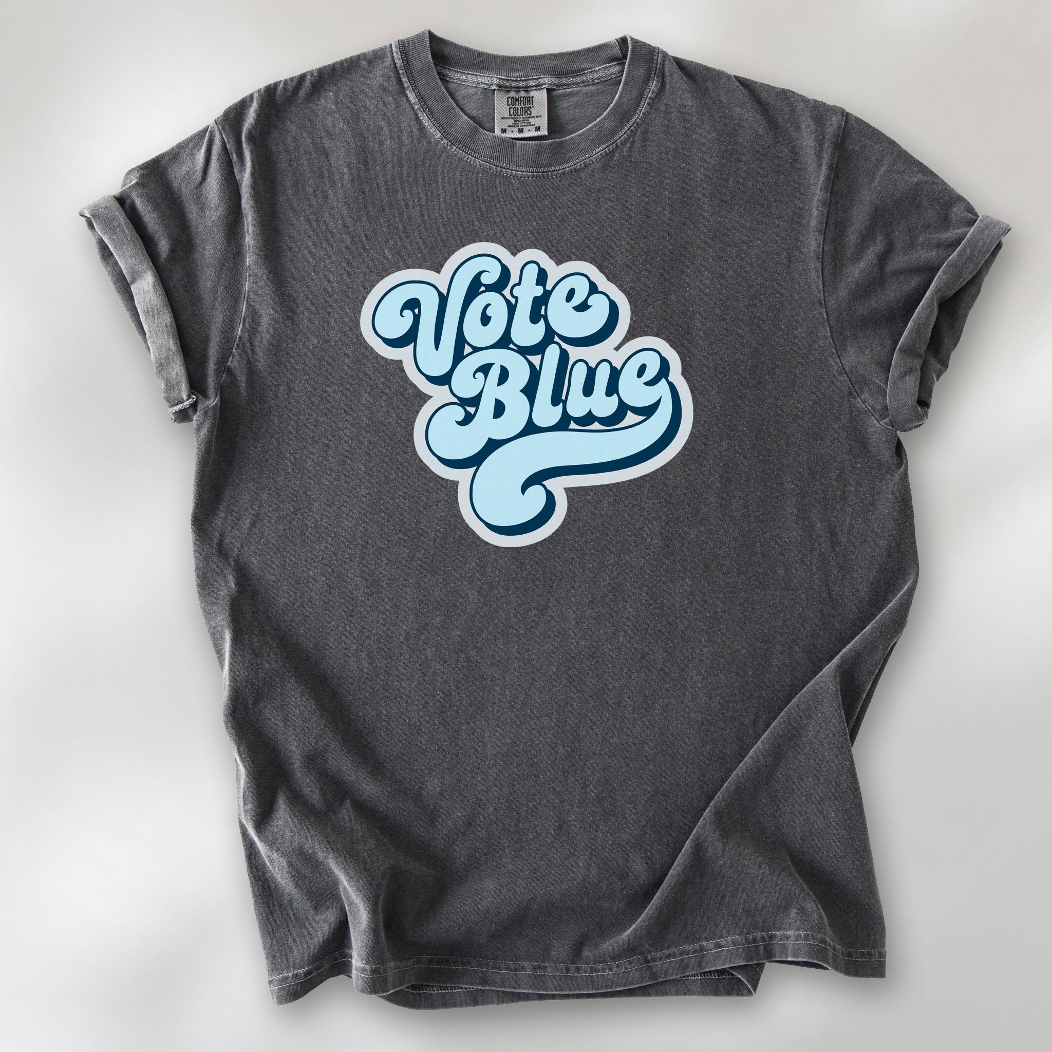 Pepper t-shirt featuring a retro blue "Vote Blue" script graphic.