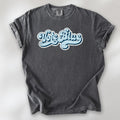 Pepper t-shirt featuring distressed retro script text reading "Vote Blue" in light blue vintage lettering.