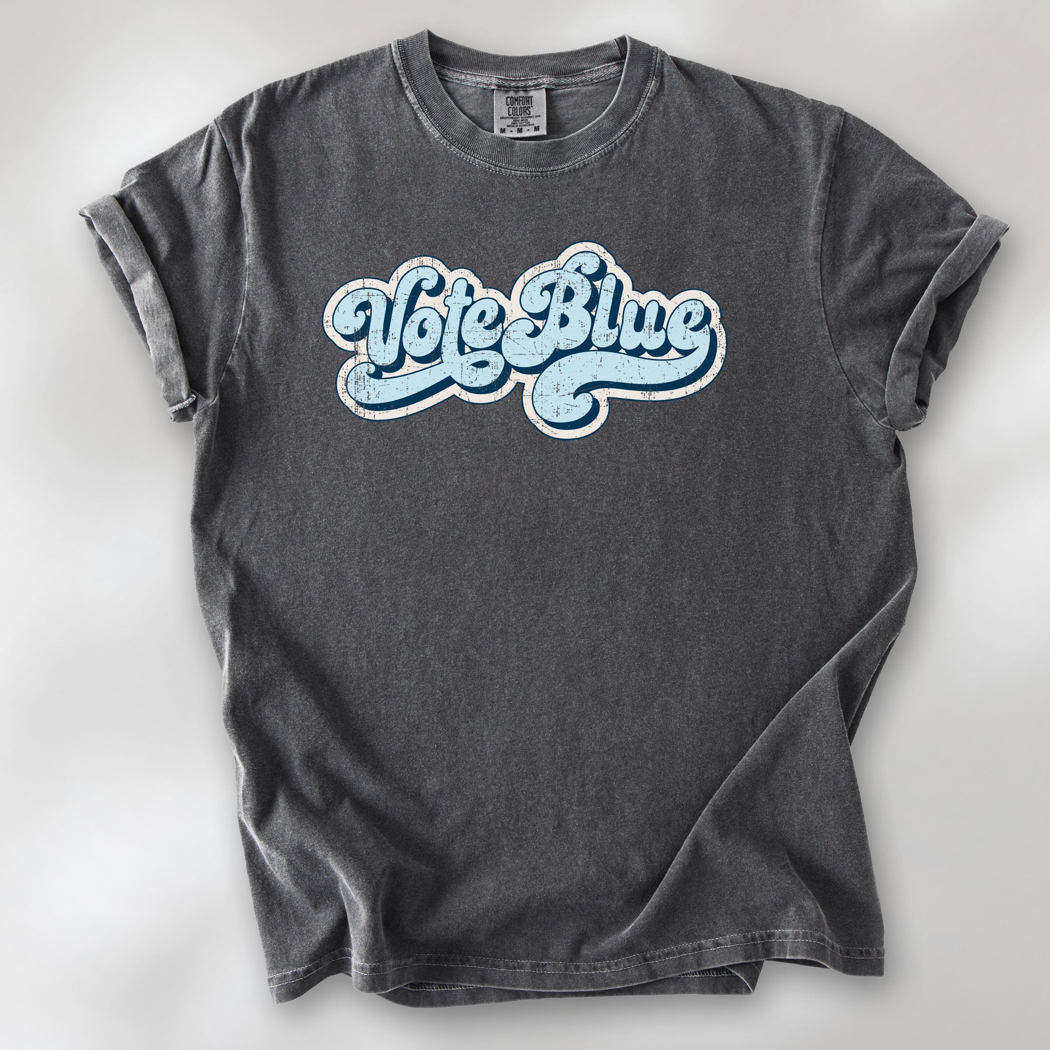 Pepper t-shirt featuring distressed retro script text reading "Vote Blue" in light blue vintage lettering.