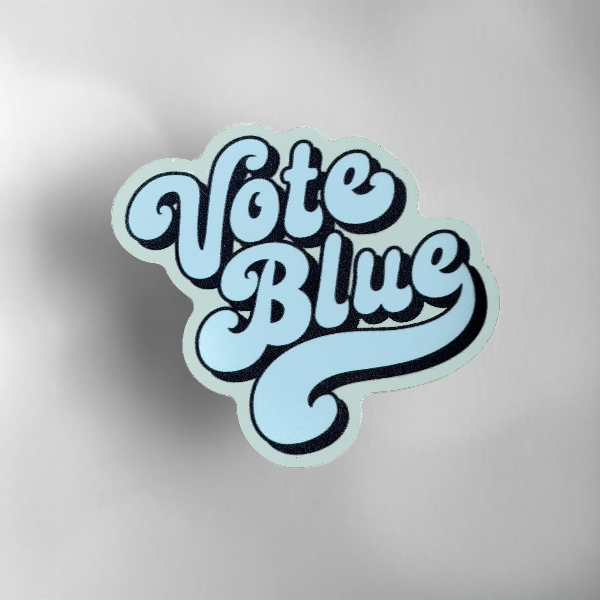 Die-cut Vote Blue vinyl sticker with retro blue typography.