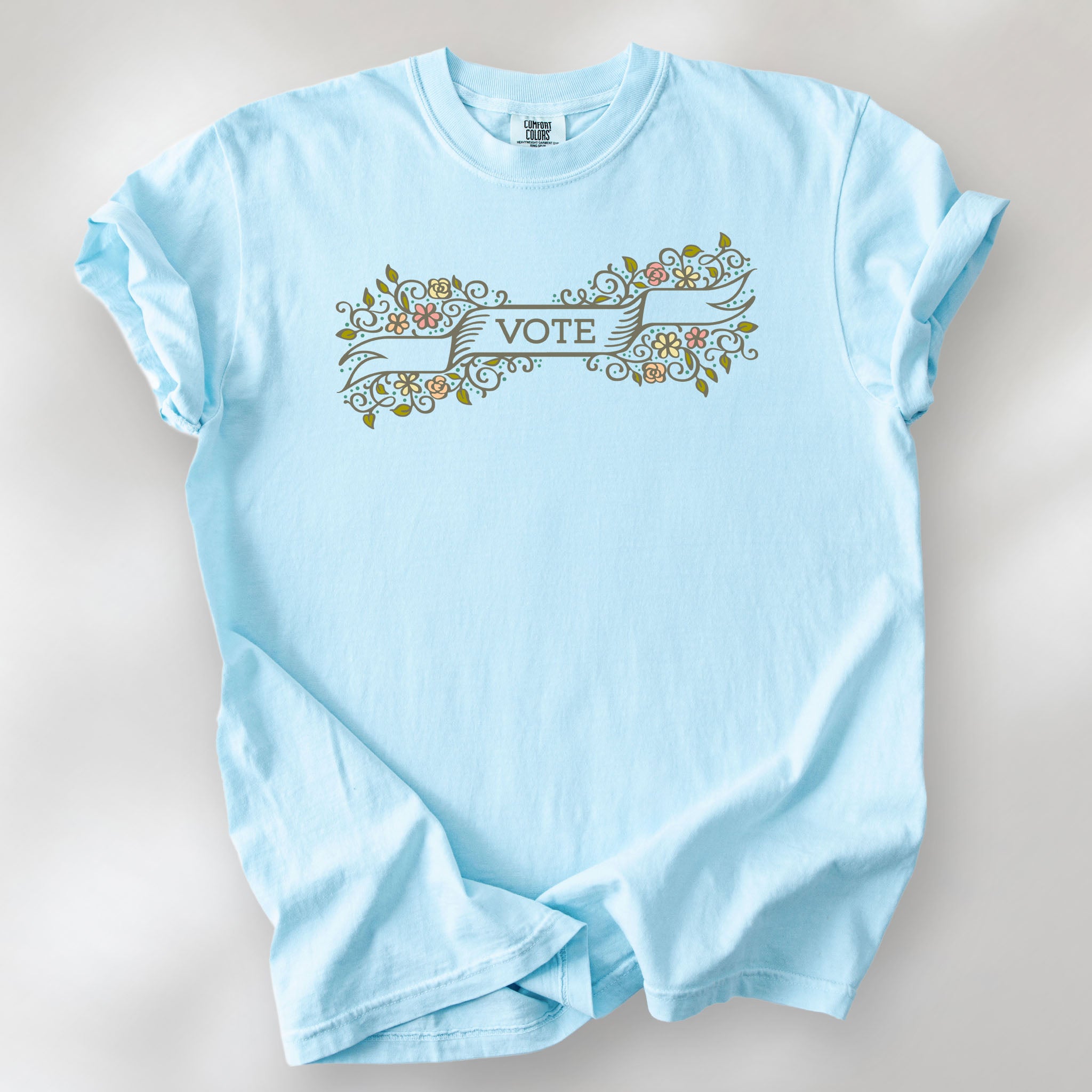 Chambray t-shirt with vintage style floral illustration and a banner reading “vote” in the center.