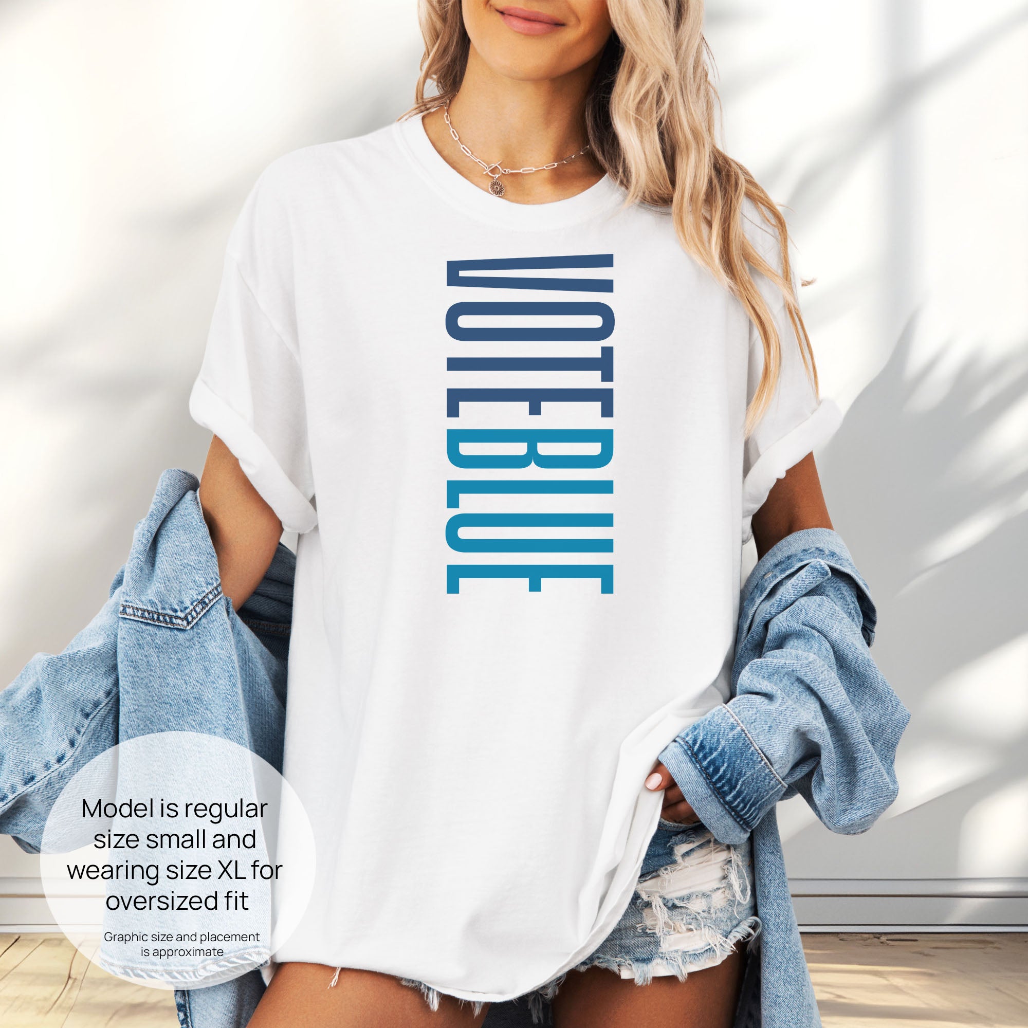Female model wearing oversized white t-shirt featuring the words "VOTE BLUE" stacked vertically in bold minimalist blue typography. Includes size and fit information for the model who is 6 feet 0 inches, 176 pounds, and wearing a size XL shirt.
