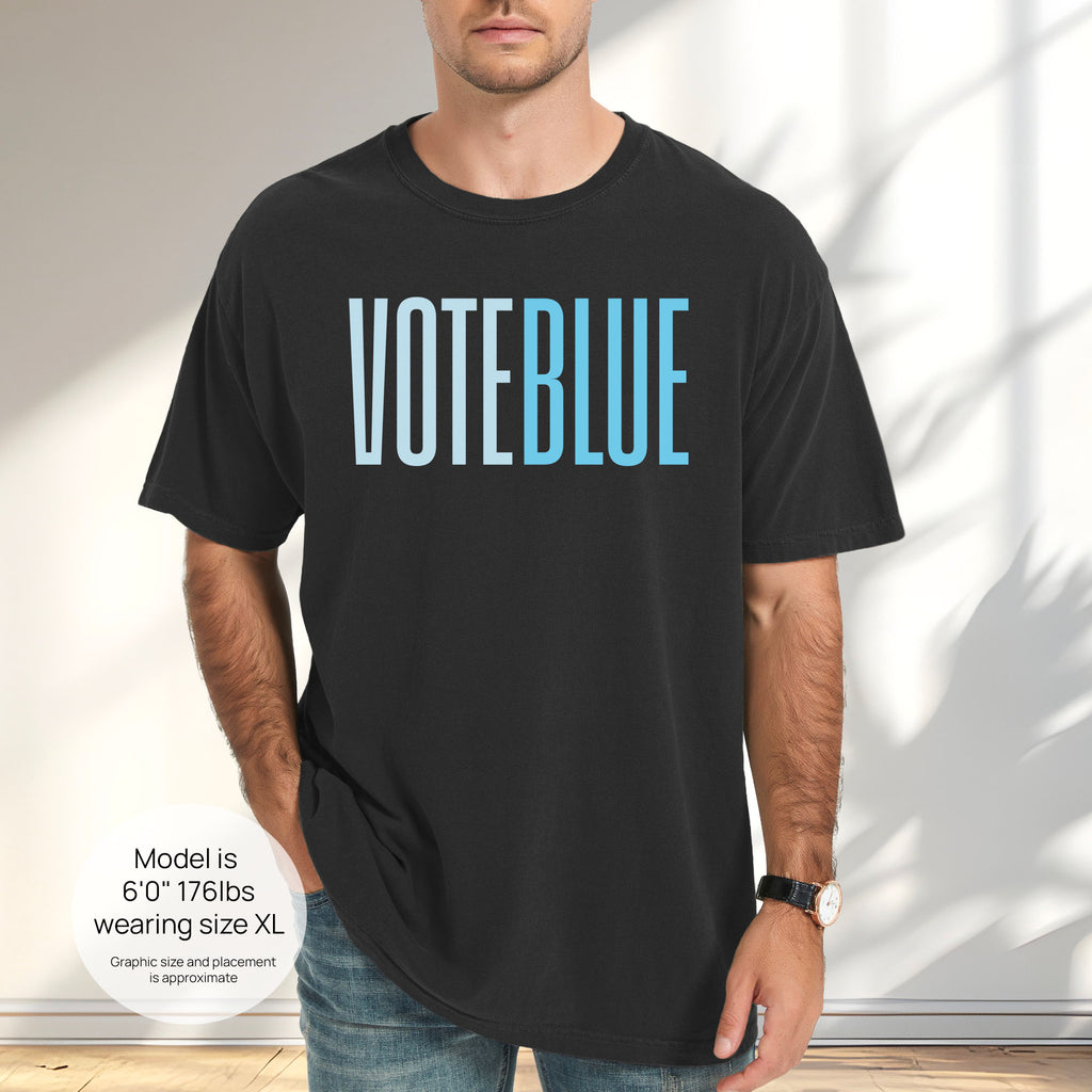 Male model wearing black t-shirt featuring the words "VOTE BLUE" in bold horizontal blue geometric typography with a clean minimalist design. Includes size and fit information for the model who is 6 feet 0 inches, 176 pounds, and wearing a size XL shirt.
