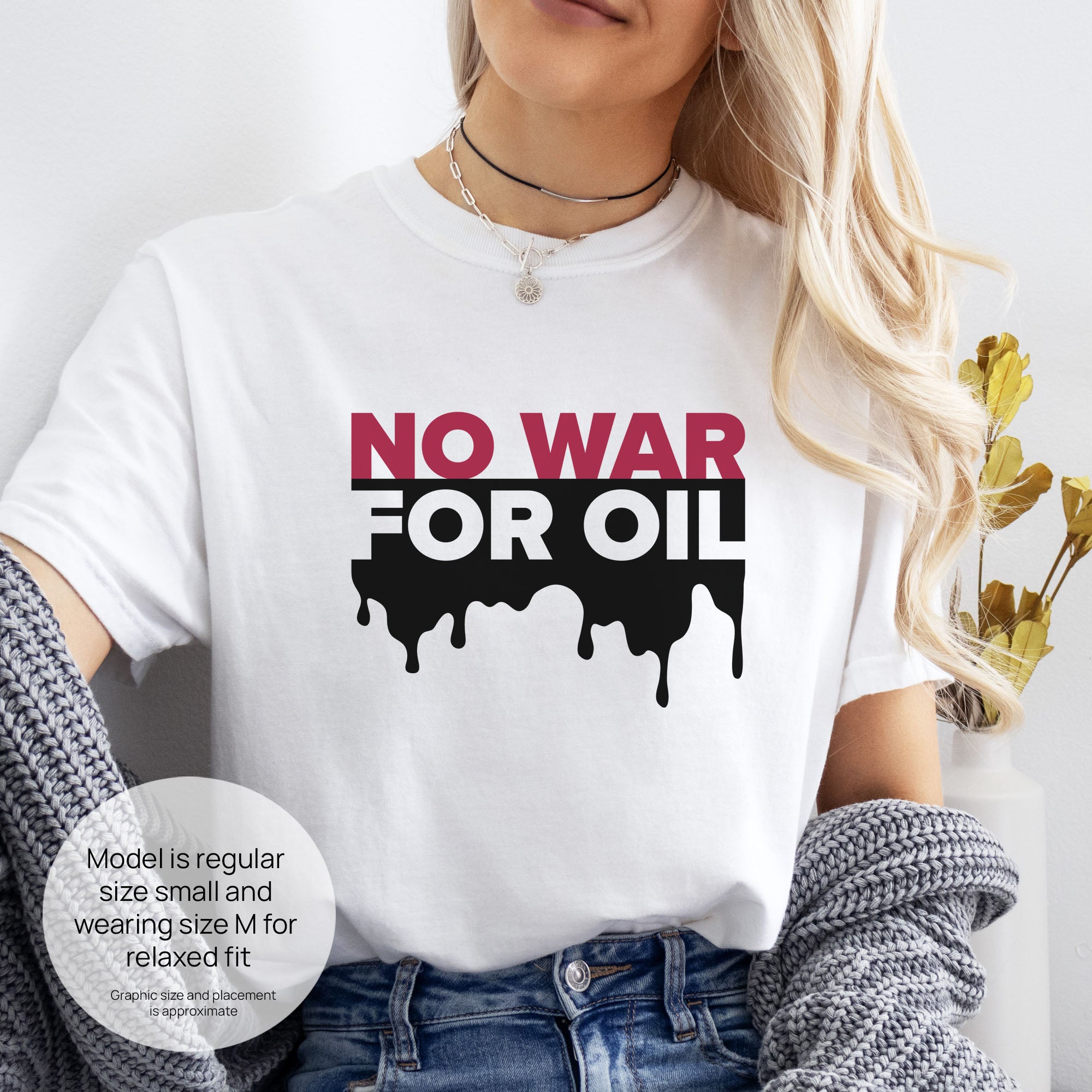 Female model wearing white protest t-shirt with bold text reading “No War for Oil” and dripping oil graphic, anti-war political shirt. Includes size and fit information for the model who is regular size small, and wearing a size M shirt for a relaxed fit.
