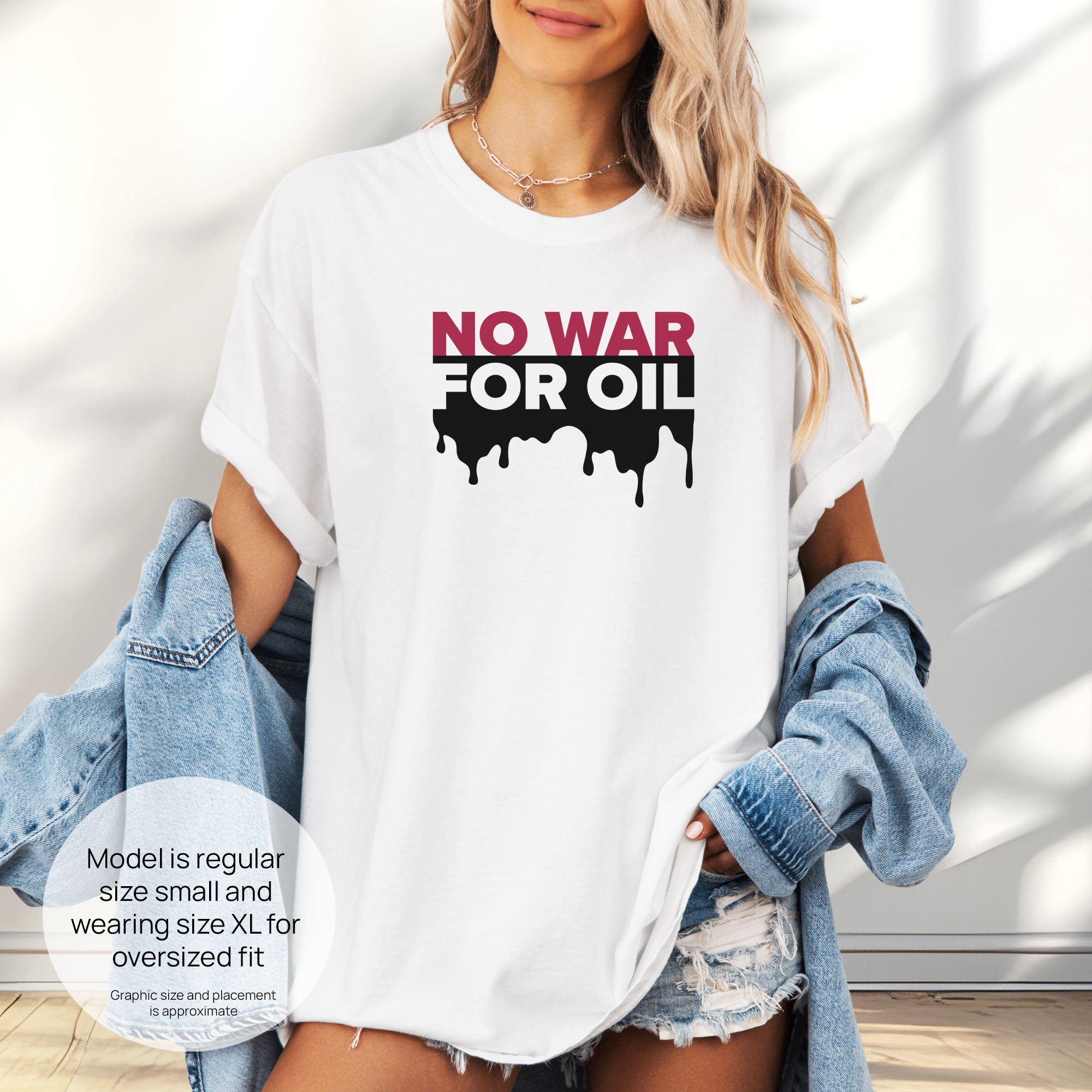 Female model wearing white protest t-shirt with bold text reading “No War for Oil” and dripping oil graphic, anti-war political shirt. Includes size and fit information for the model who is regular size small, and wearing a size XL shirt for an oversized fit.
