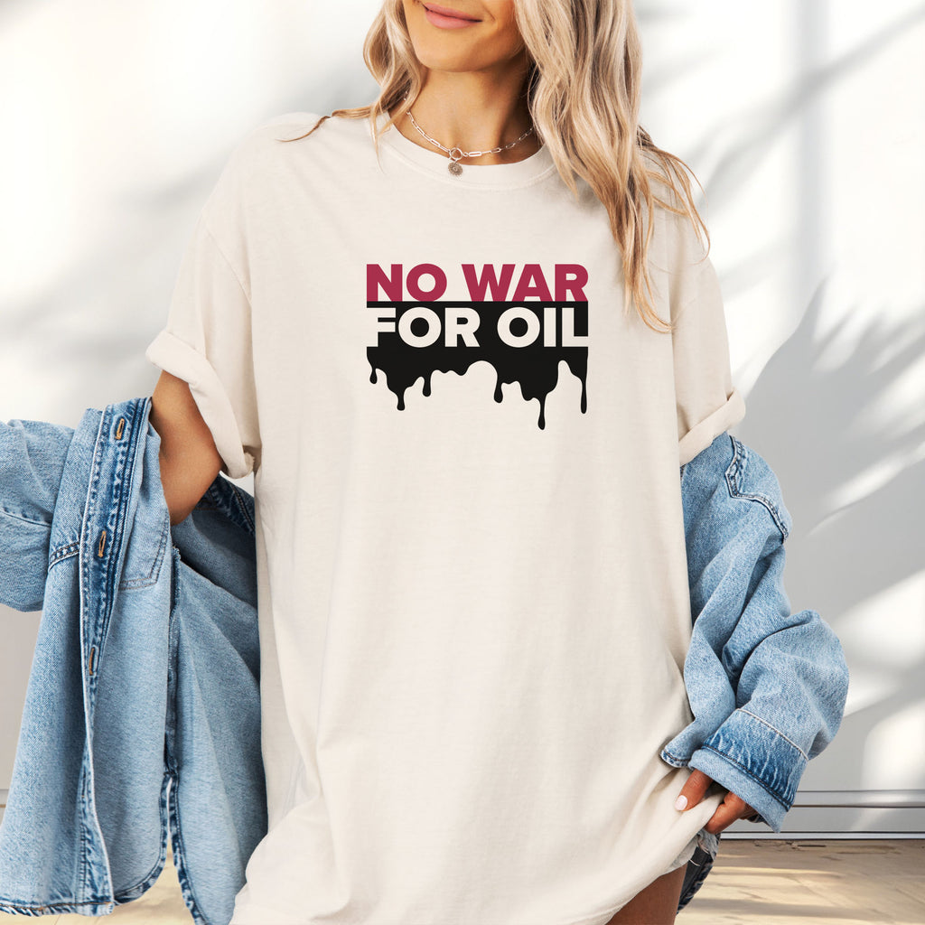 Female model wearing oversized ivory protest t-shirt with bold text reading “No War for Oil” and dripping oil graphic, anti-war political shirt.