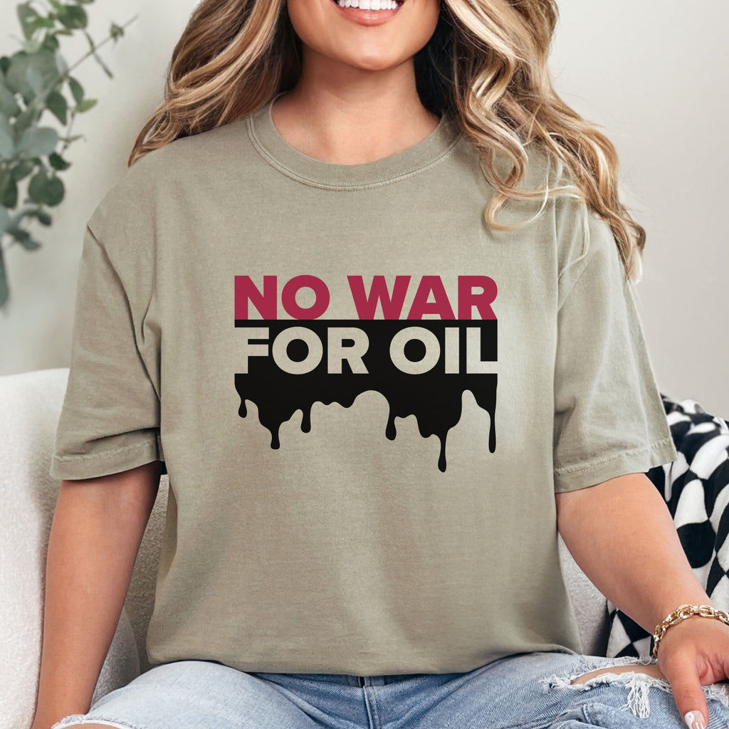 Female model wearing khaki protest t-shirt with bold text reading “No War for Oil” and dripping oil graphic, anti-war political shirt.