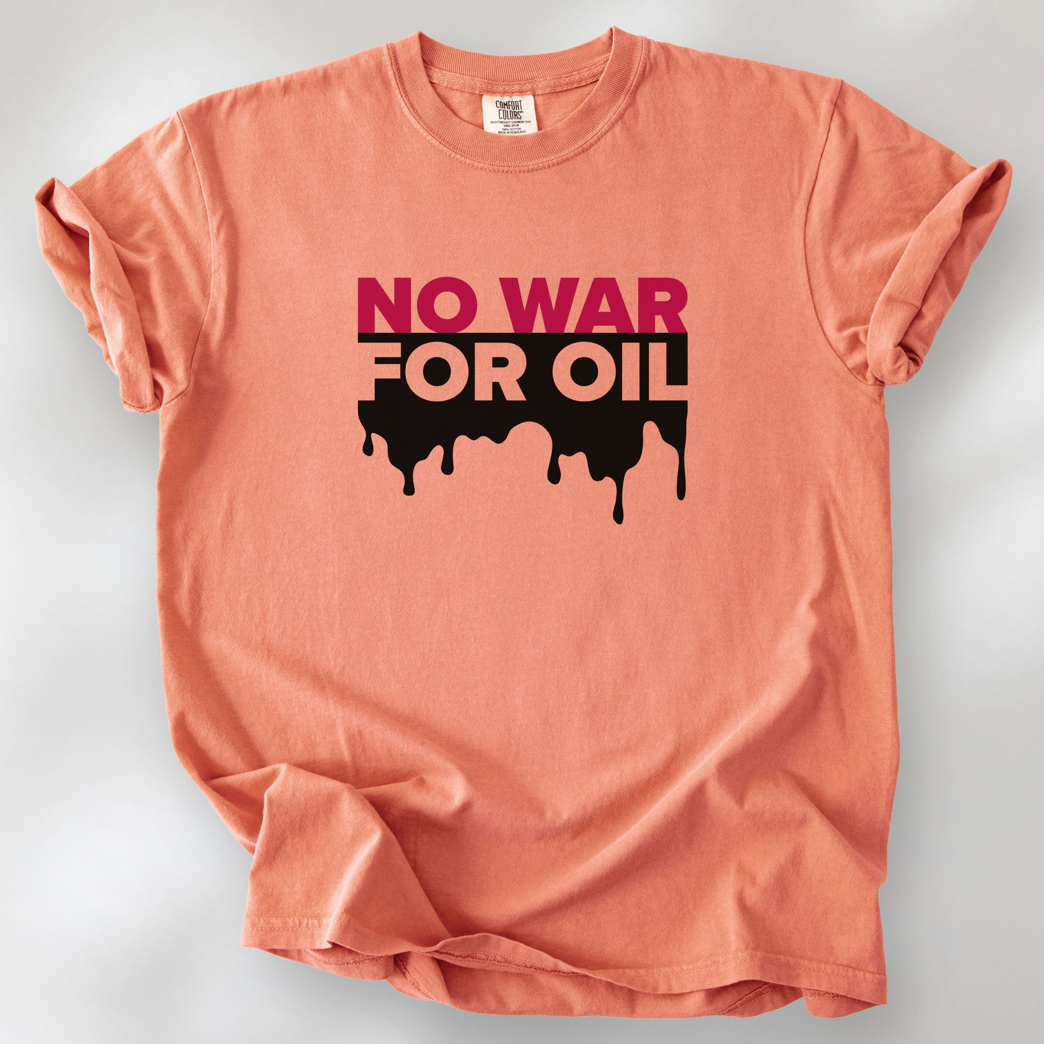 Terracotta protest t-shirt with bold text reading “No War for Oil” and dripping oil graphic, anti-war political shirt.