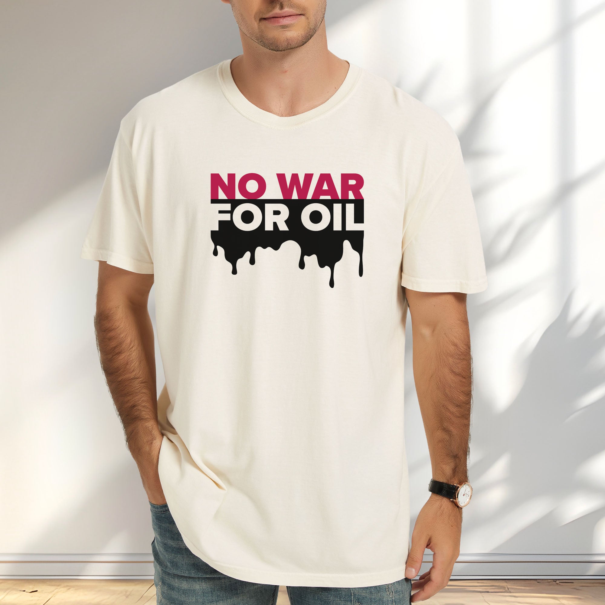 Male model wearing ivory protest t-shirt with bold text reading “No War for Oil” and dripping oil graphic, anti-war political shirt.
