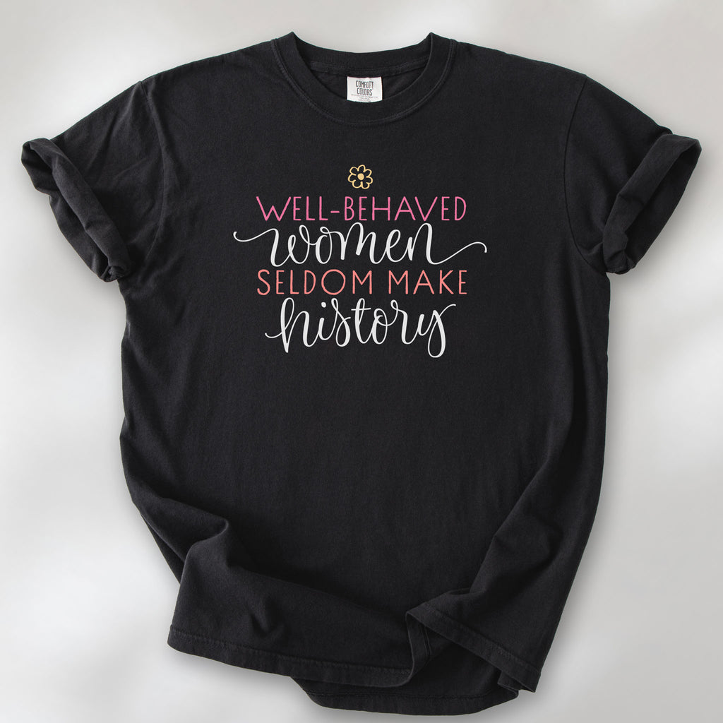 Black feminist t-shirt with colorful text that reads “Well-behaved women seldom make history” — empowering women’s rights shirt and activist apparel.