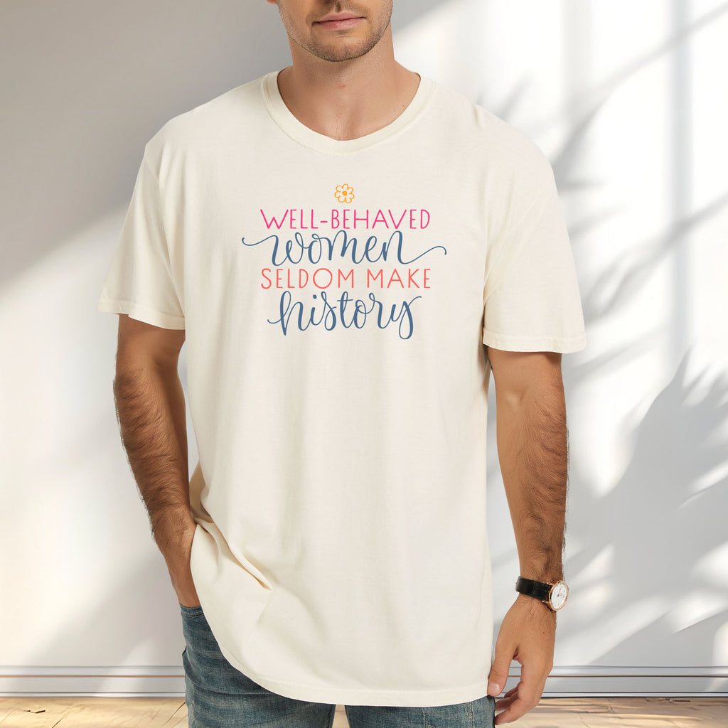 Male model wearing ivory feminist t-shirt with colorful text that reads “Well-behaved women seldom make history” — empowering women’s rights shirt and activist apparel.