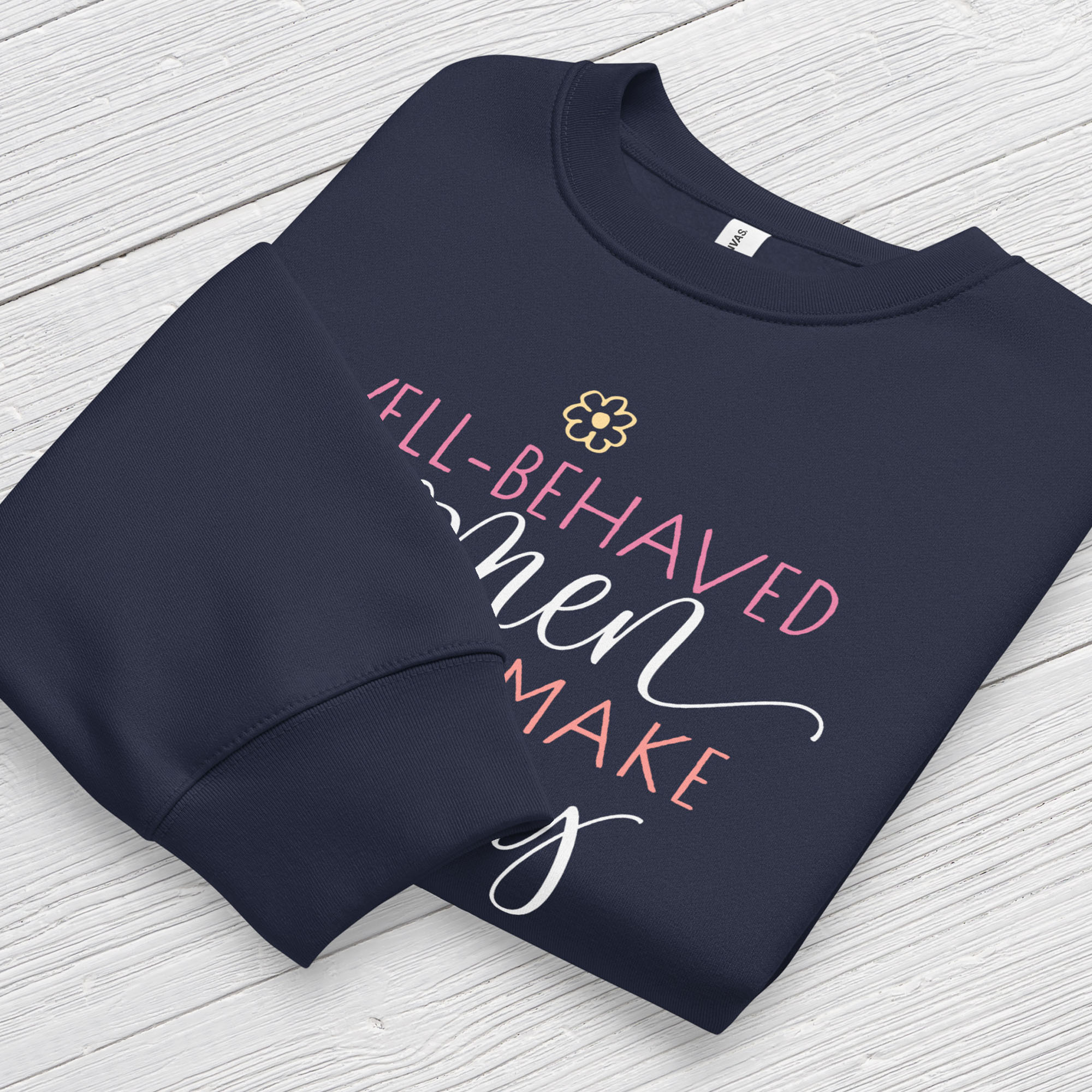 Folded navy crewneck sweatshirt with stylized text graphic that reads "well-behaved women seldom make history",  displaying neck and sleeve cuffs.