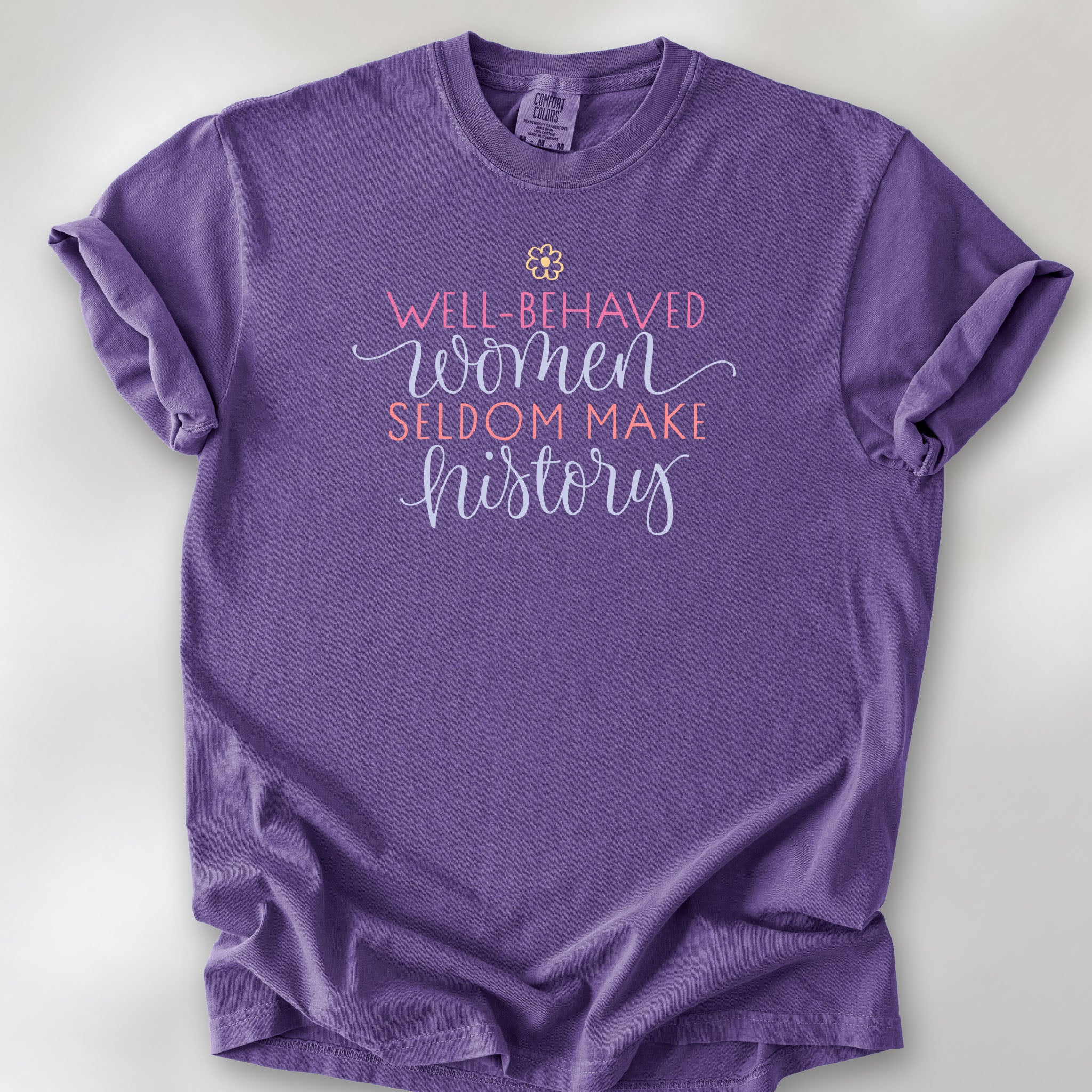 Grape t-shirt with graphic styled text that reads "well-behaved women seldom make history."