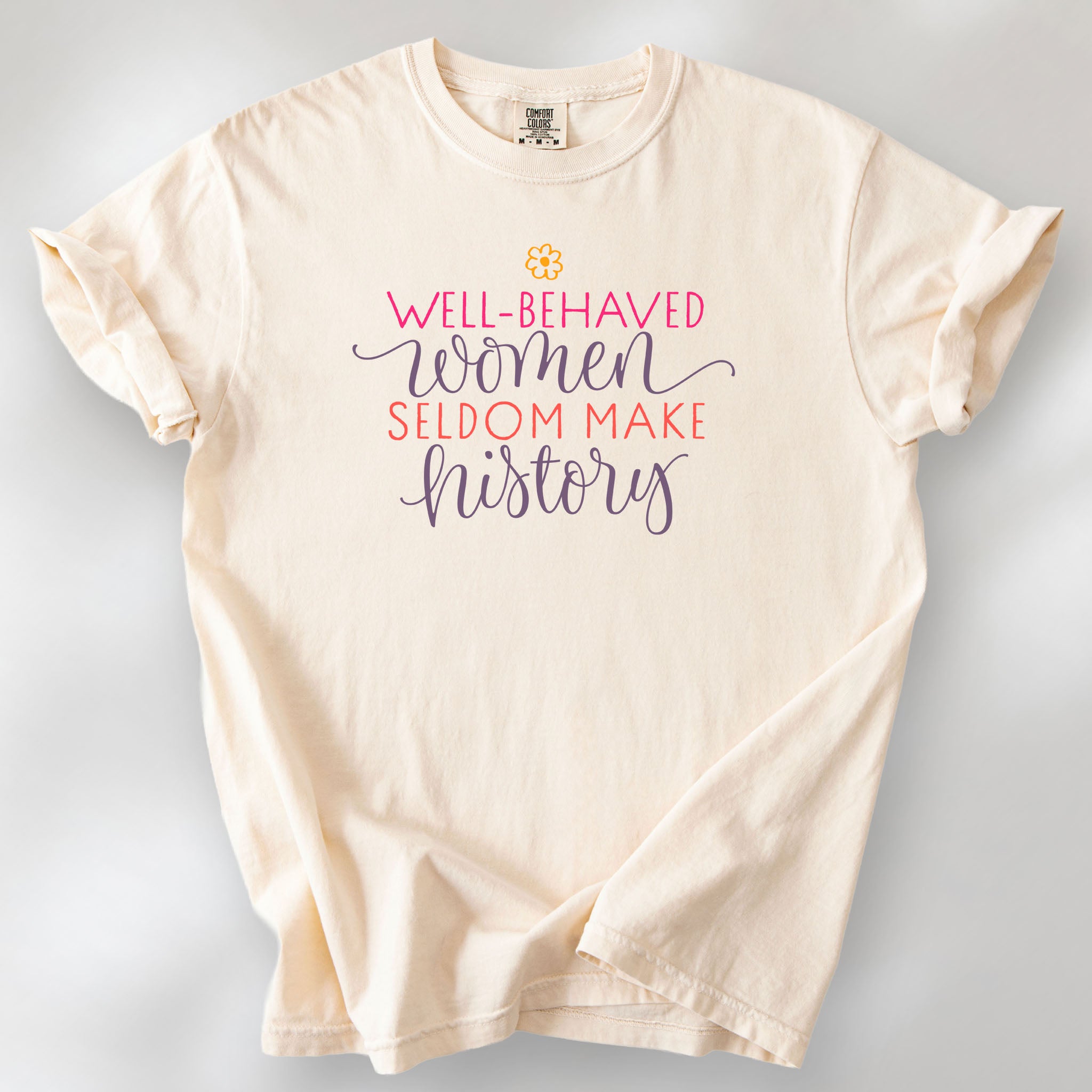 Ivory t-shirt with graphic styled text that reads "well-behaved women seldom make history."