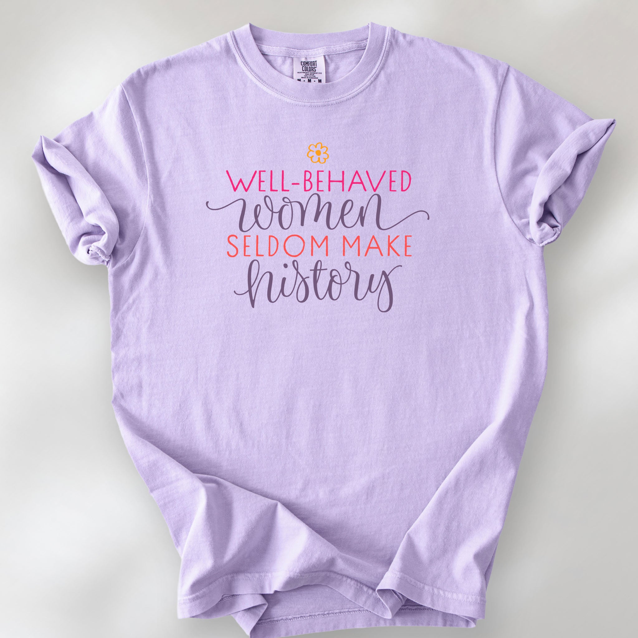 Orchid t-shirt with graphic styled text that reads "well-behaved women seldom make history."