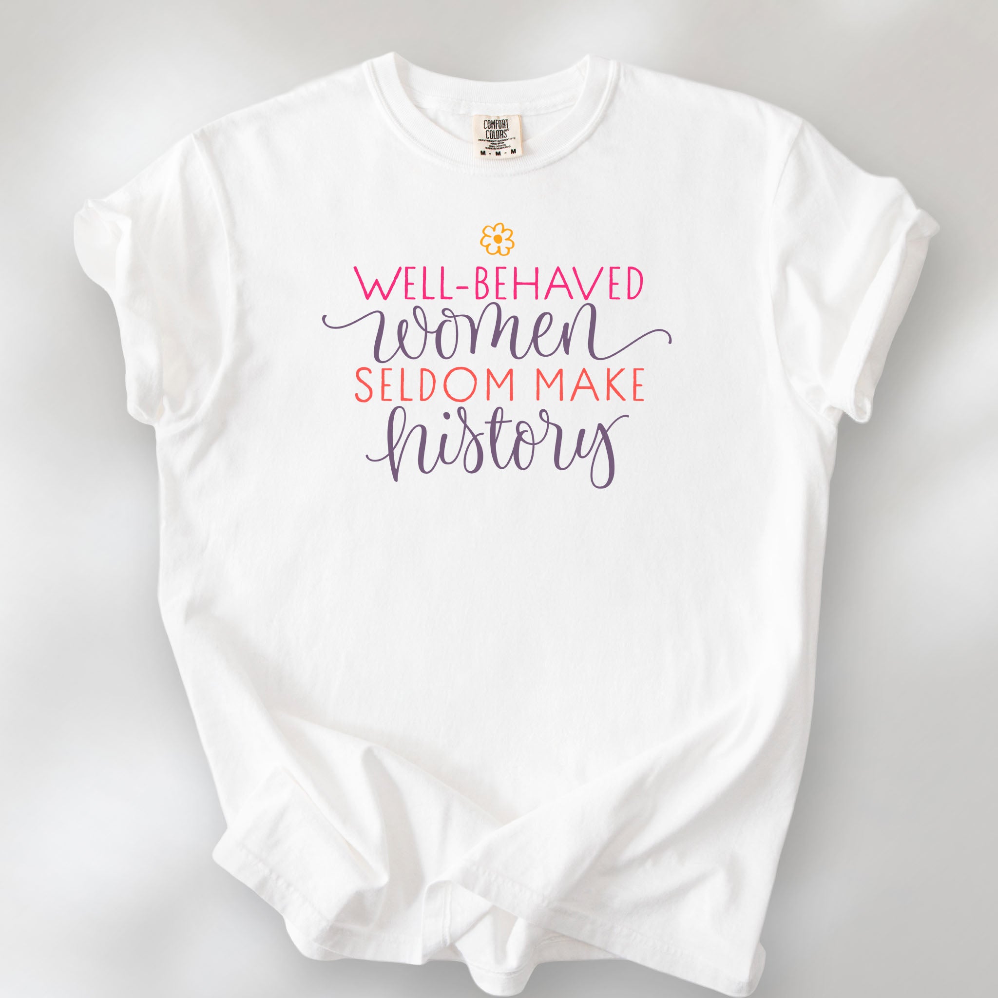 White t-shirt with graphic styled text that reads "well-behaved women seldom make history."