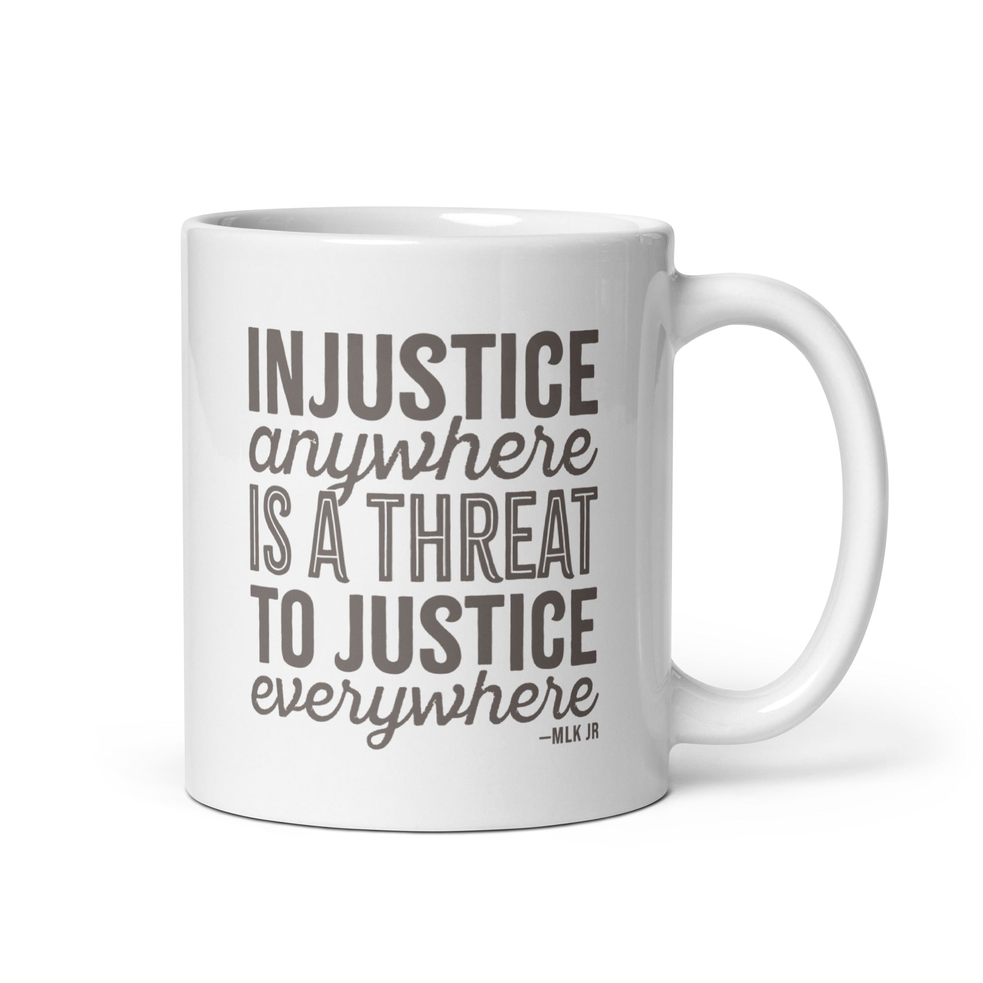 11 ounce white ceramic mug with bold text graphic reading “injustice anywhere is a threat to justice everywhere,” a quote from MLK Junior from Letters from Birmingham Jail.