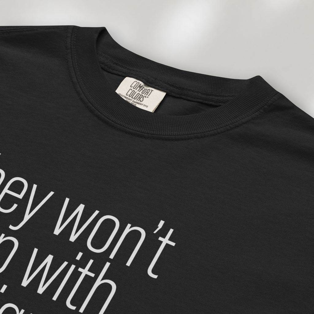 Closeup detail of black shirt with minimalist text that reads "they won't stop with immigrants."