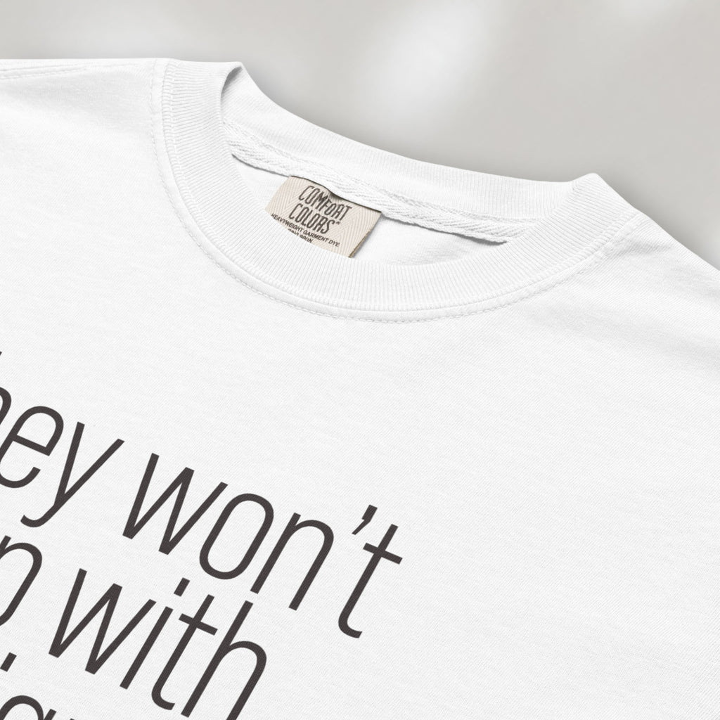 Closeup detail of white shirt with minimalist text that reads "they won't stop with immigrants."
